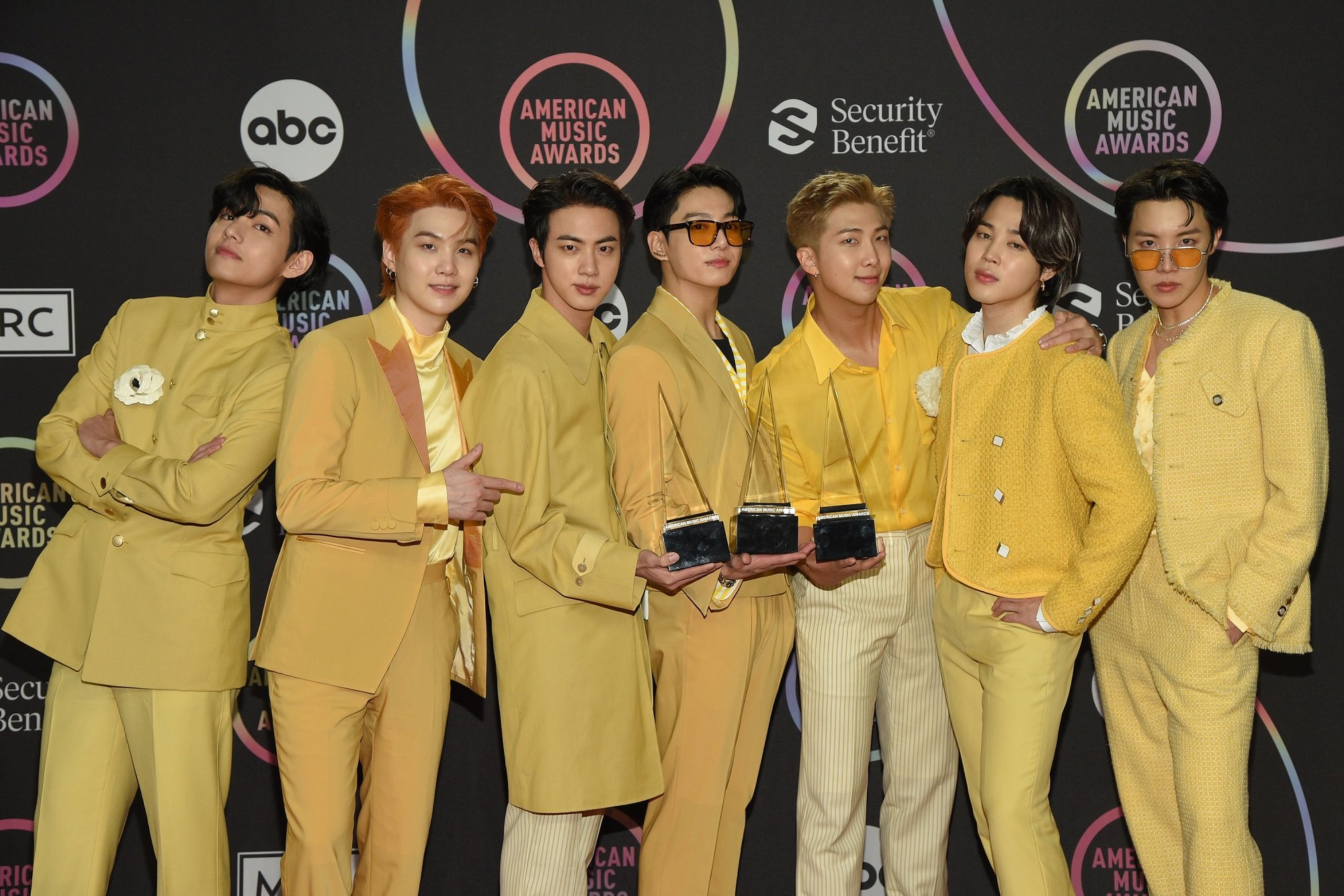 V, Suga, Jin, Jungkook, RM, Jimin, and J-Hope of BTS pose with their awards at the 2021 American Music Awards