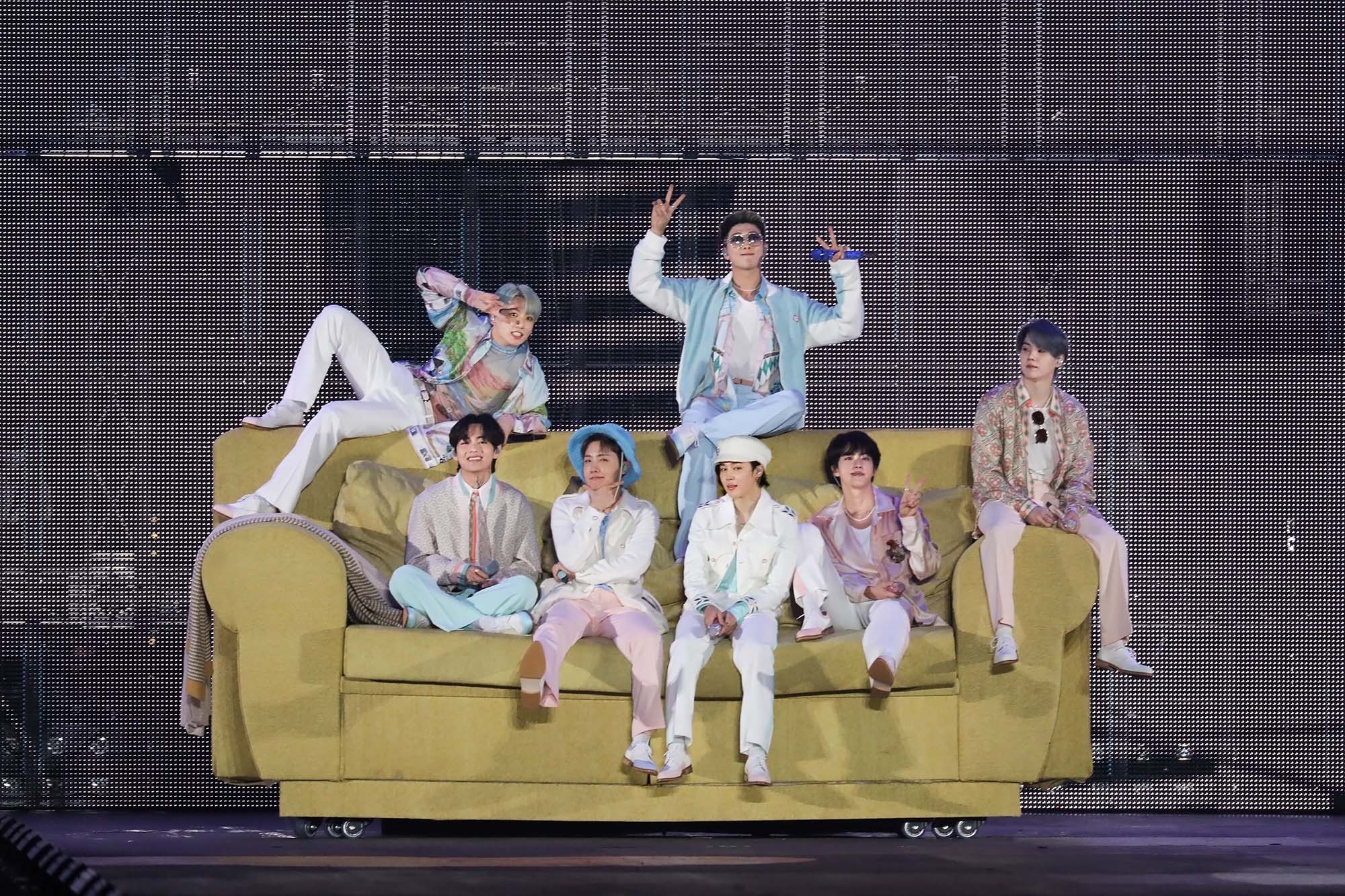 The members of BTS sit on a couch during 'Permission to Dance On Stage'