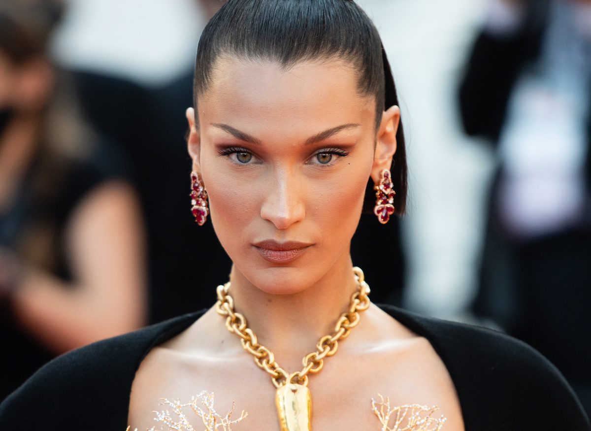 Bella Hadid stares into the camera at an event.