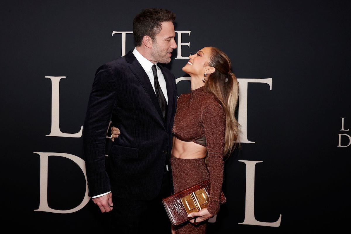 Ben Affleck and Jennifer Lopez stare at each other and smile at an event.