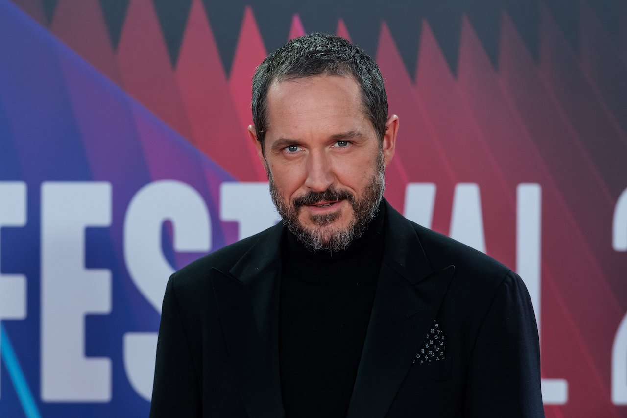 Bertie Carvel poses on the red carpet in a black outfit.