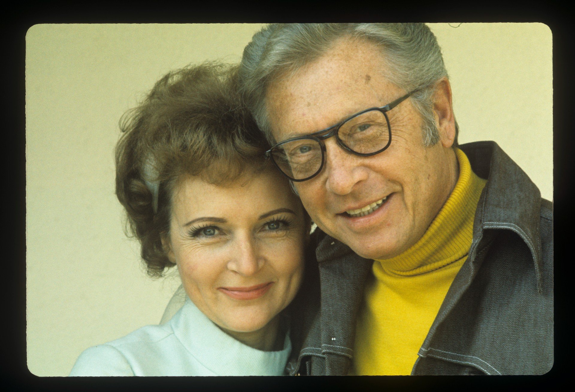Betty White and Allen Ludden pose together and smile