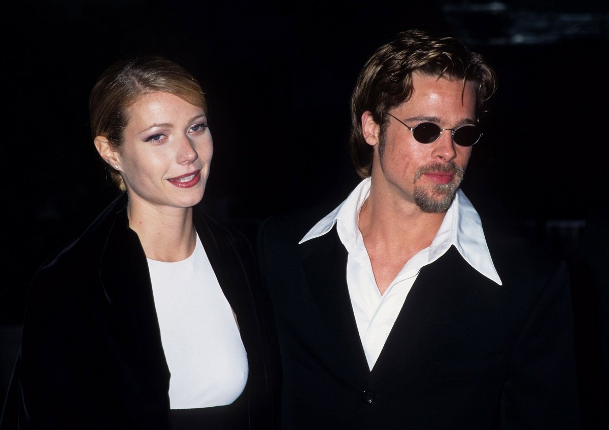 Brad Pitt and Gwyneth Paltrow posing and smiling in matching outfits