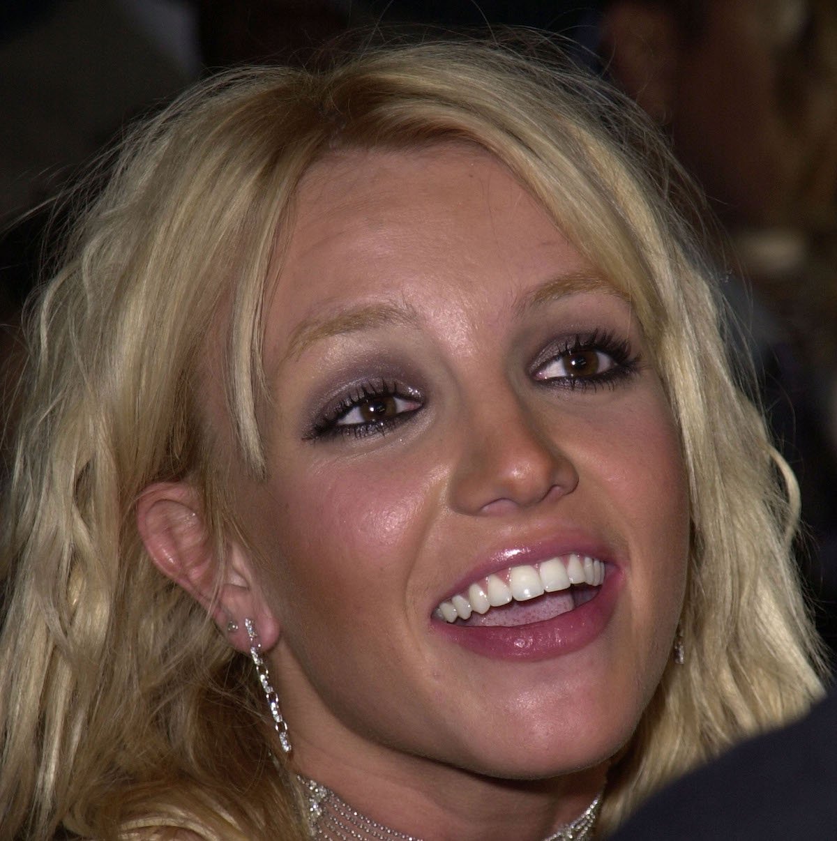 Britney Spears in a smiling headshot.