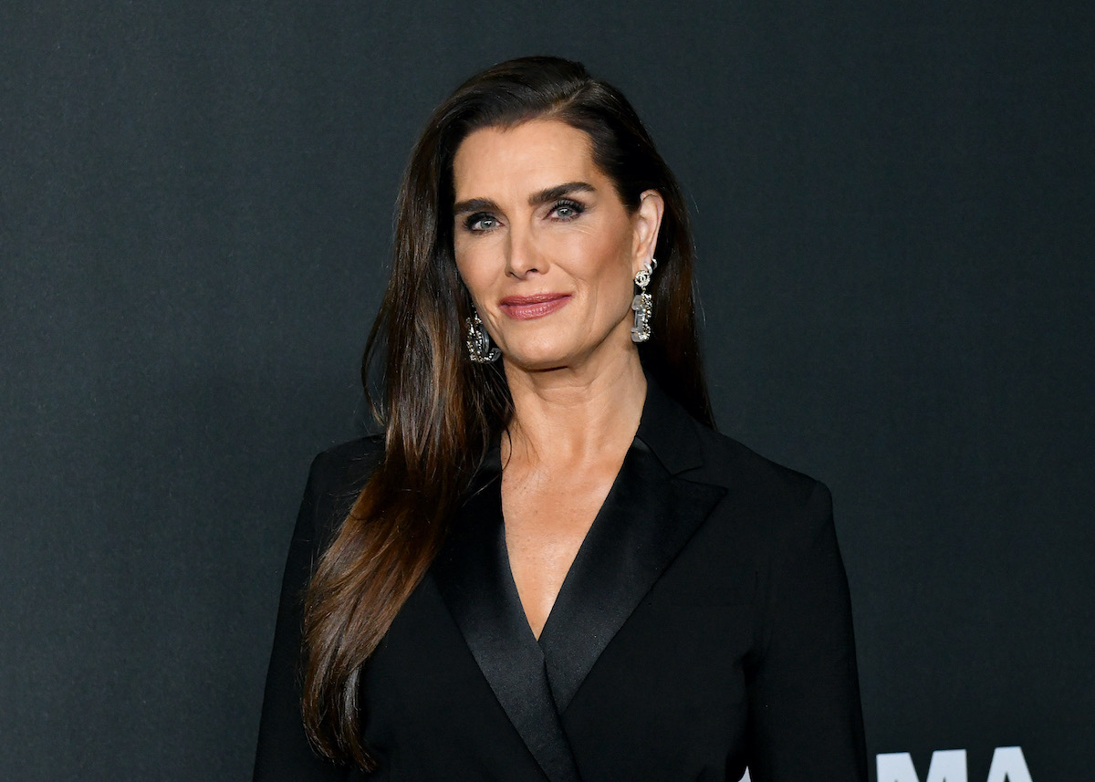 Brooke Shields smiling in front of a black background