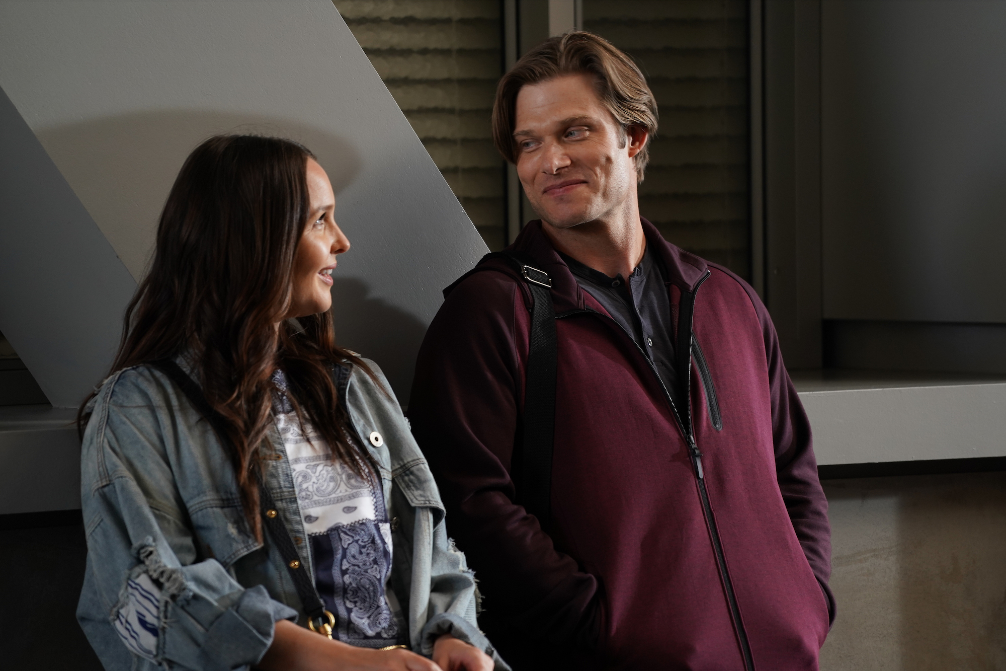 Camilla Luddington, and Chris Carmack talking to each other in a hospital in 'Grey's Anatomy.'