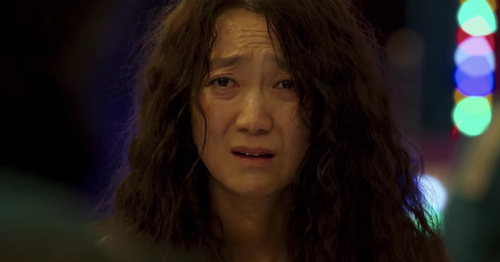 Character Han Mi-nyeo sexualization in 'Squid Game' K-drama with messy hair and crying.