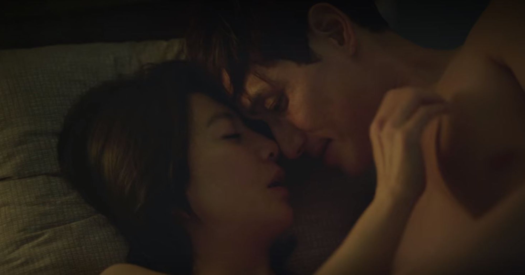Character Ji Sun-woo and husband in 'The World of the Married' K-drama sex scene kissing in bed.