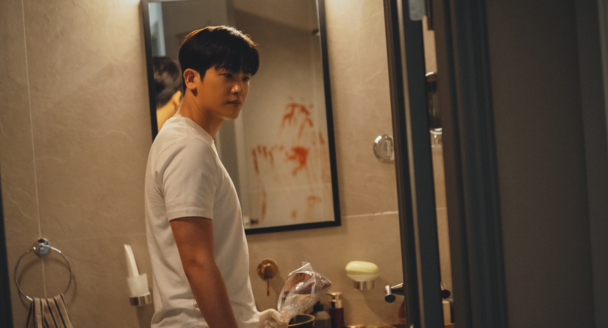 Character Jung Yi-hyun for 'Happiness' episode 3 wearing white shirt in bloody bathroom.