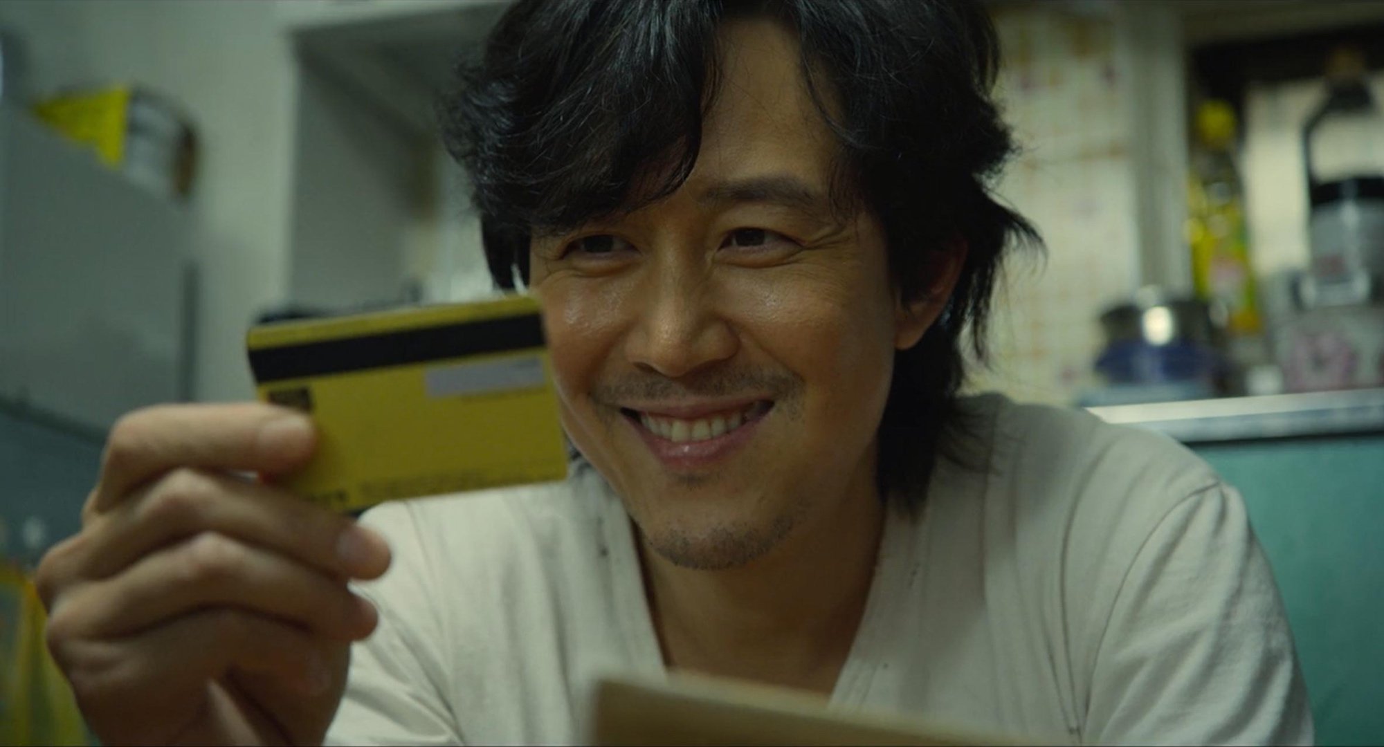 Character Seong Gi-hun for 'Squid Game' based on real person looking at debit card.