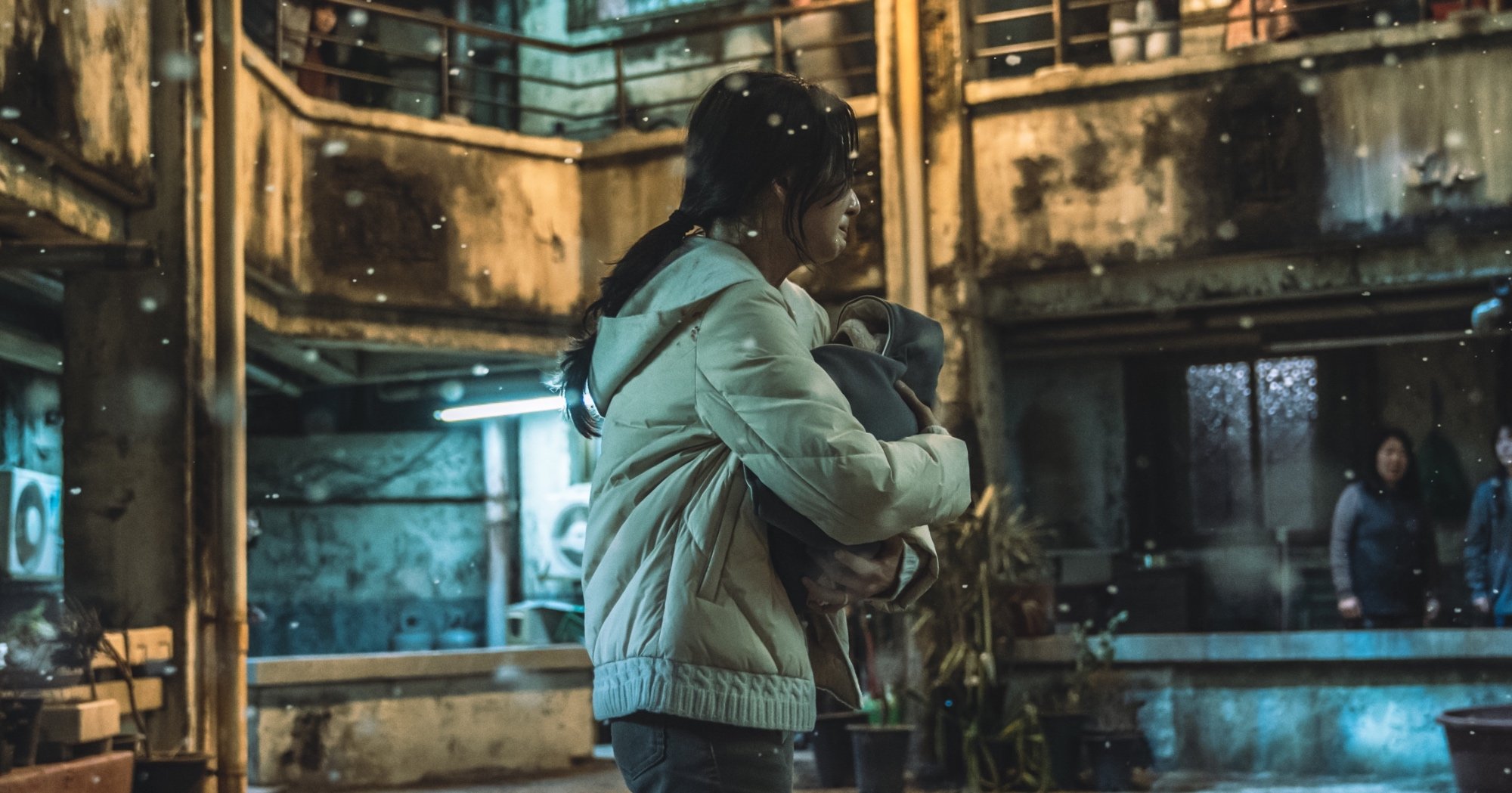 Character Song So-hyun and baby for 'Hellbound' standing in residential building.