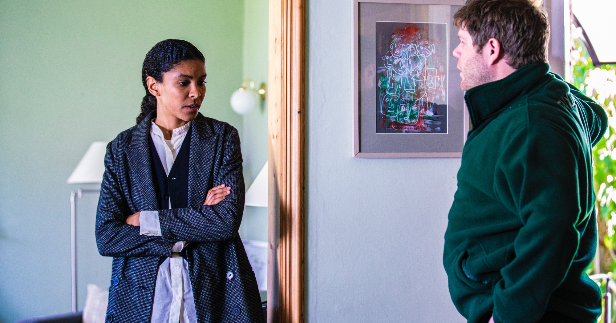 Characters Emily Baxter and Eric Turner for 'Ragdoll' Episode 3 standing in living room.