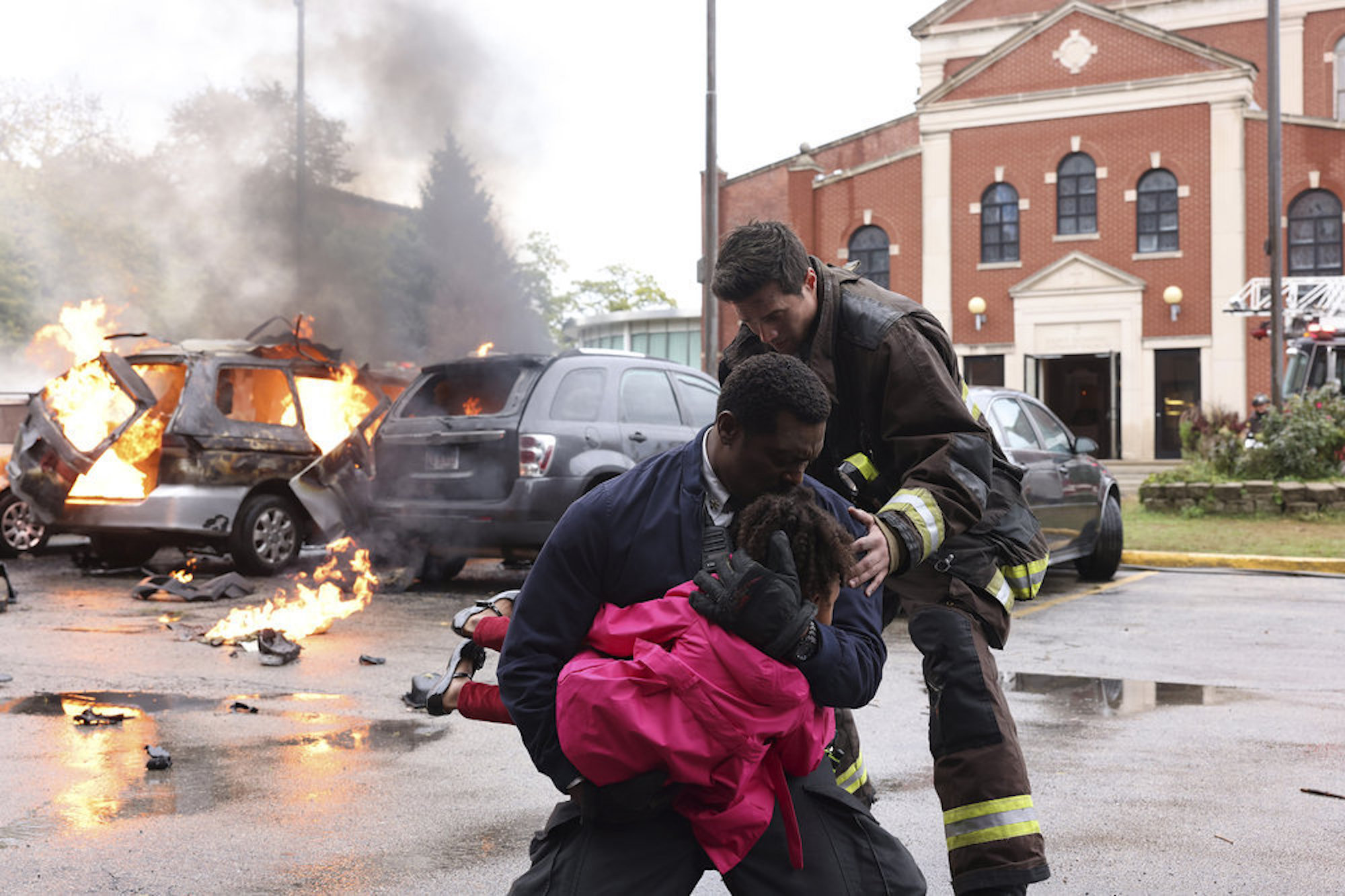 Wallace Boden hugging a young girl with another firefighter next to them in 'Chicago Fire' Season 10 Episode 7. The new firefighter could replace Matt Casey