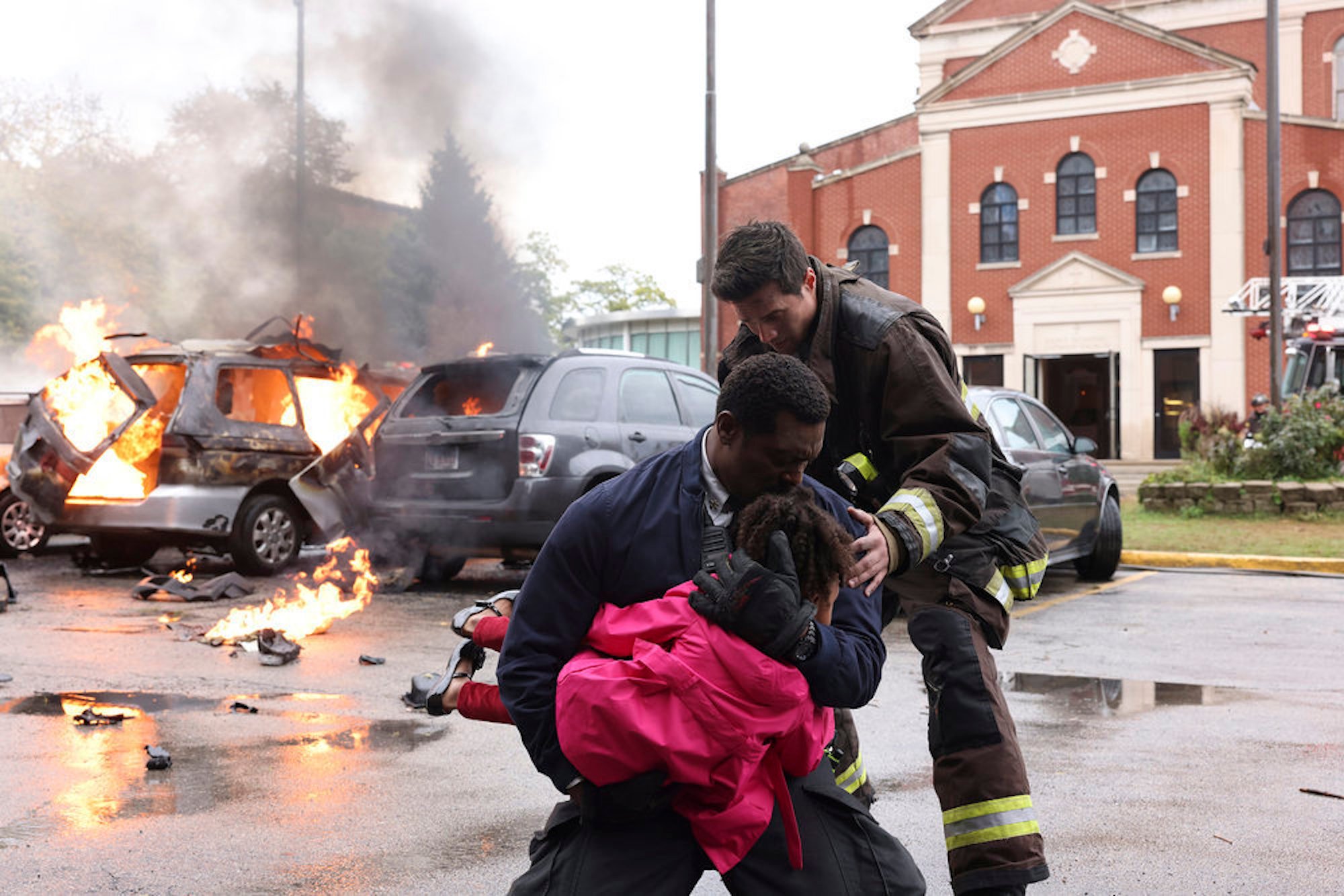 Wallace Boden hugging a young girl with another firefighter next to them in 'Chicago Fire' Season 10 Episode 7. The new firefighter could replace Matt Casey