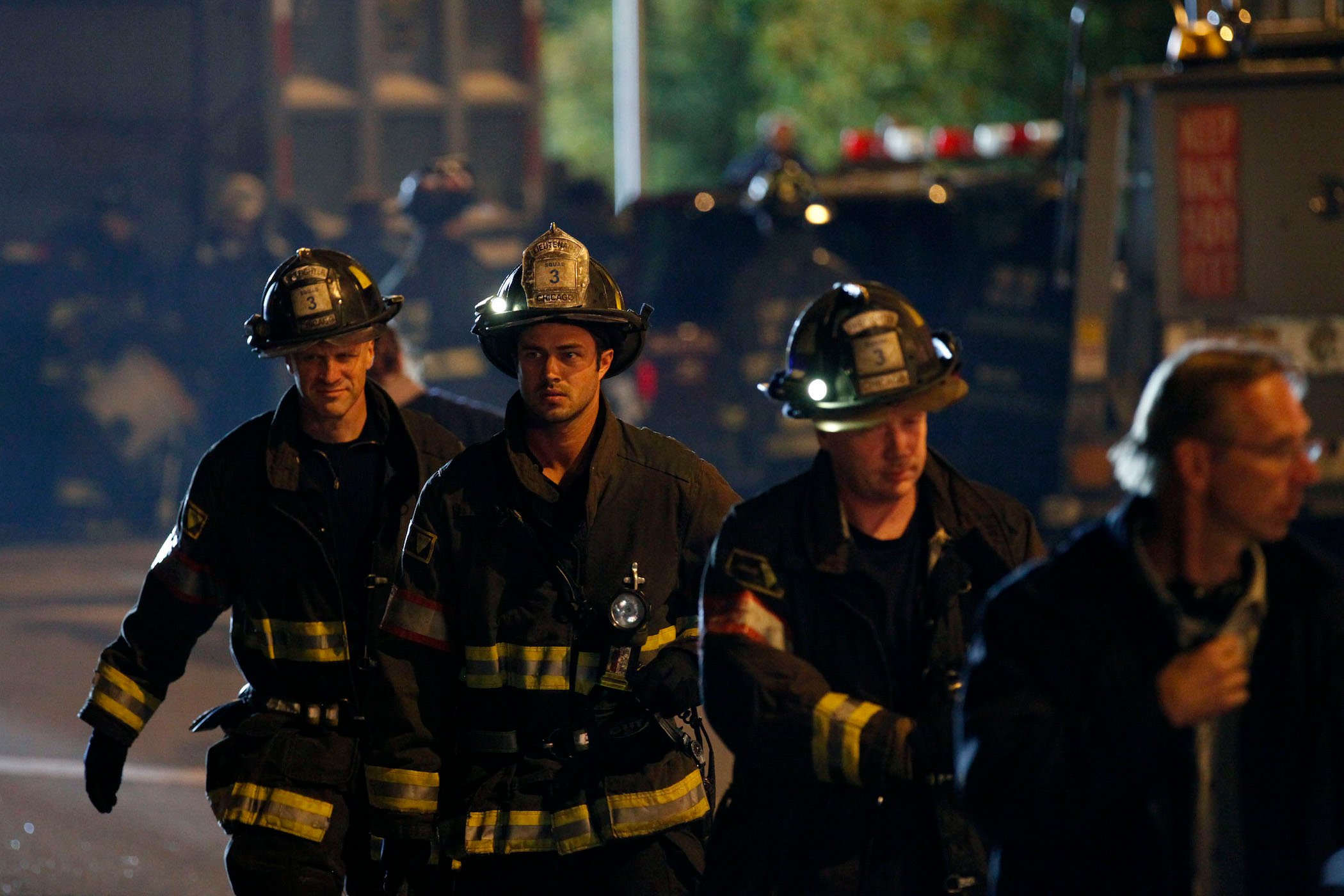 The 'Chicago Fire' crew walking in uniform at night in 'Chicago Fire' Season 1 Episode 7, the Thanksgiving-themed episode.