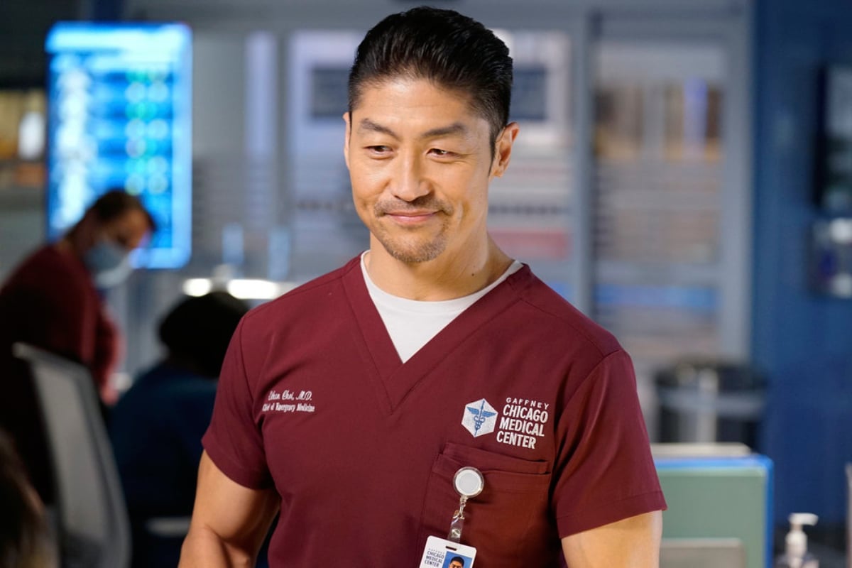 Will Dr. Ethan Choi be in the fall finale of Chicago Med Season 7? Brian Tee as Ethan Choi smiling and wearing maroon scrubs. 
