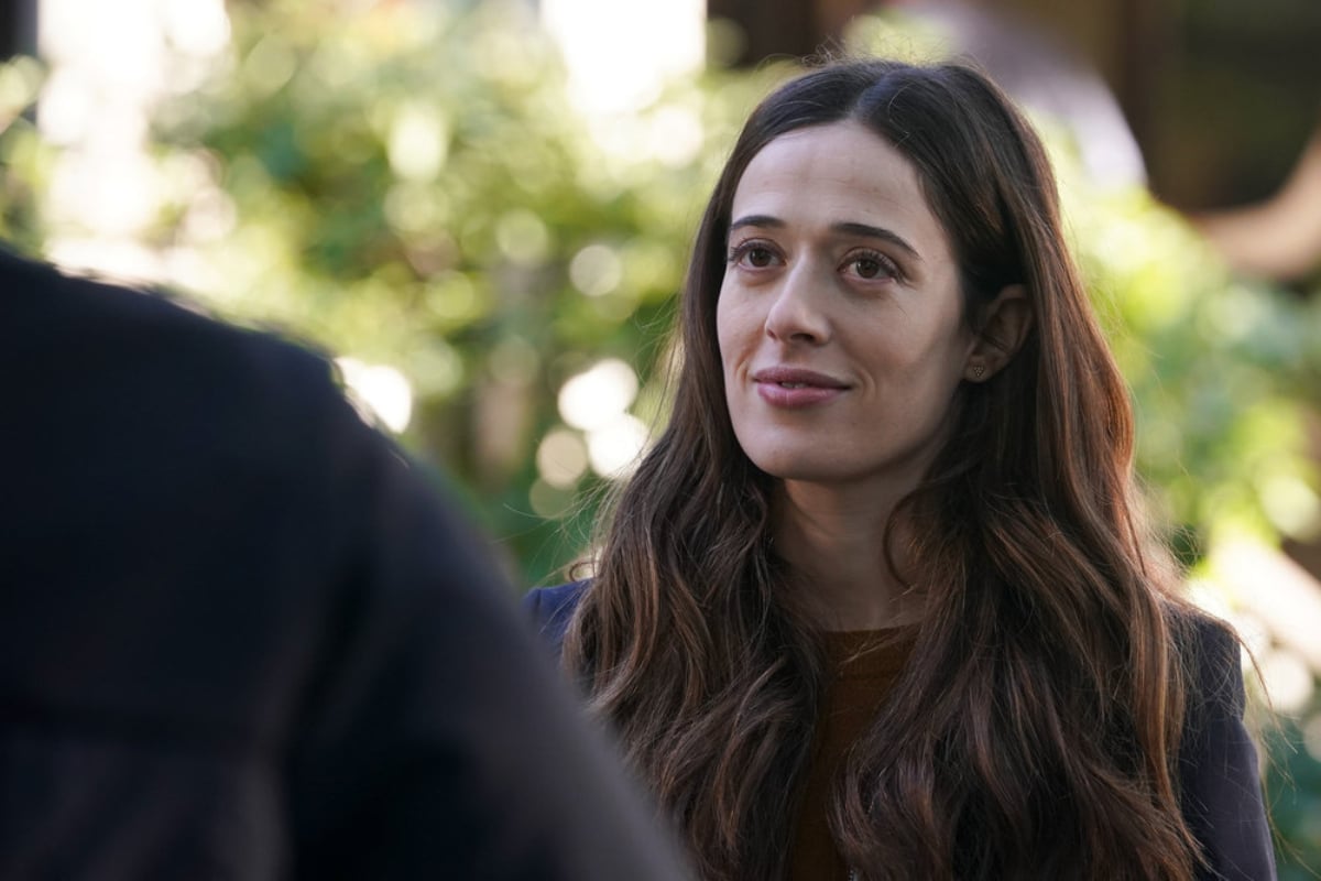 Marina Squerciati as Kim Burgess in Chicago P.D. Season 9. Kim faces someone and smiles.