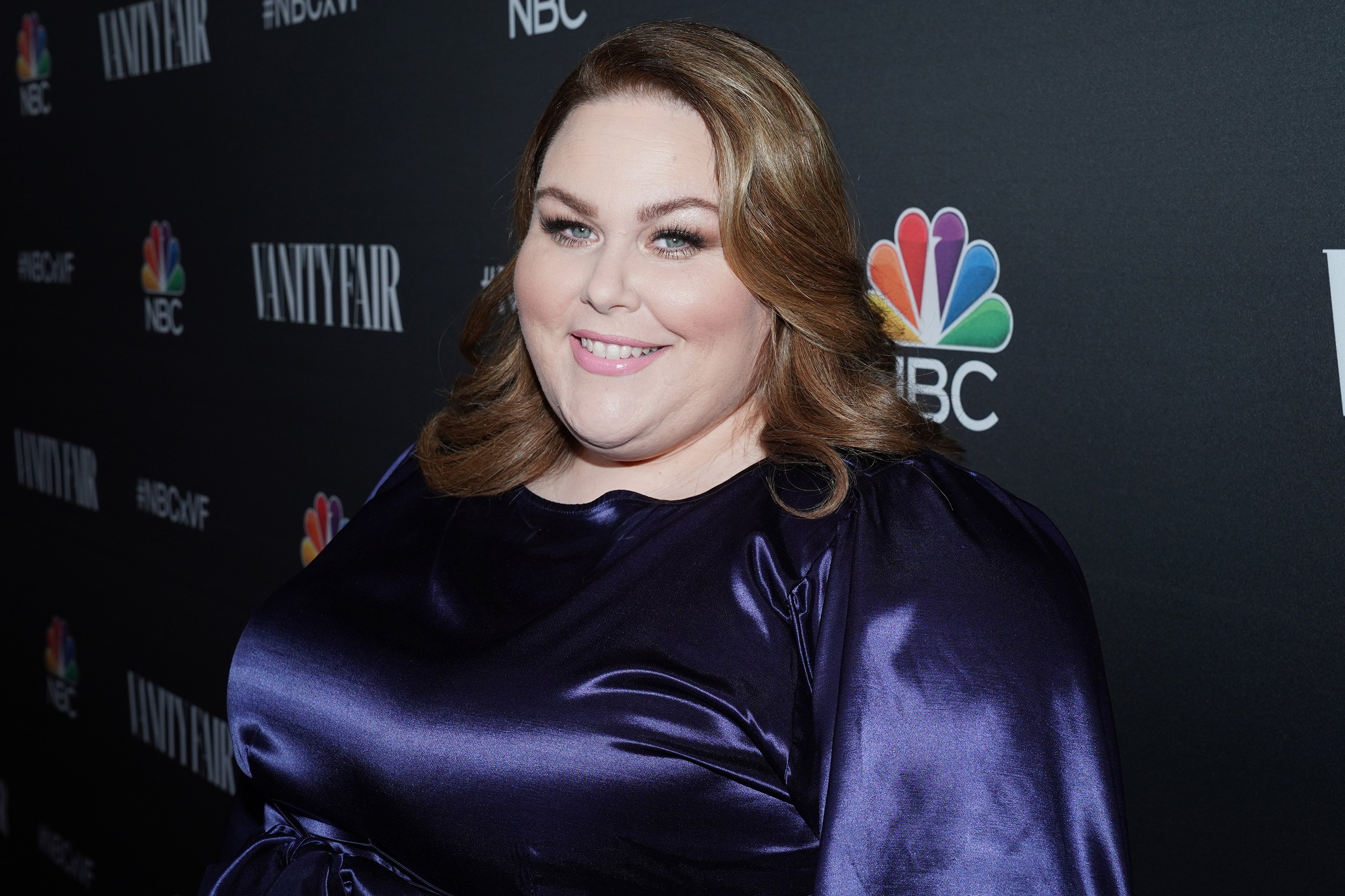 'This Is Us' Season 6 star Chrissy Metz wear a long-sleeved purple dress.