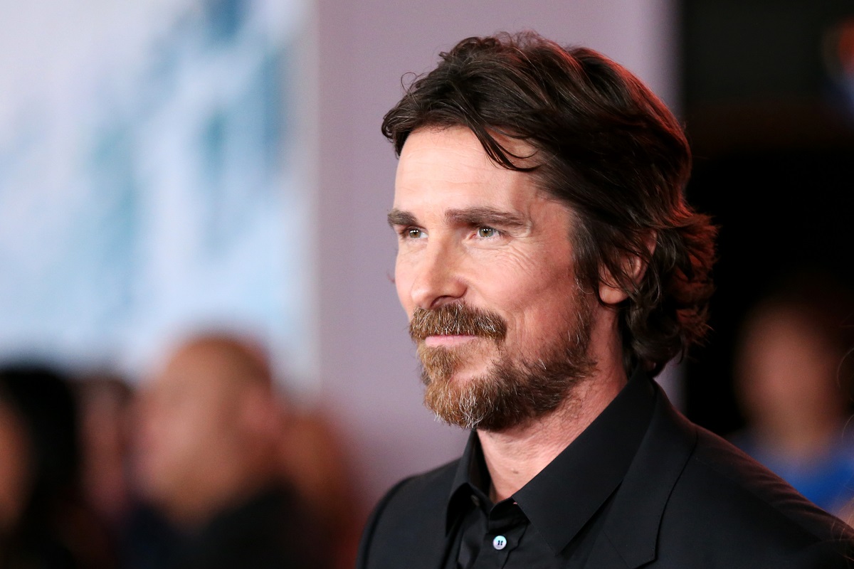 Christian Bale smirking in a suit