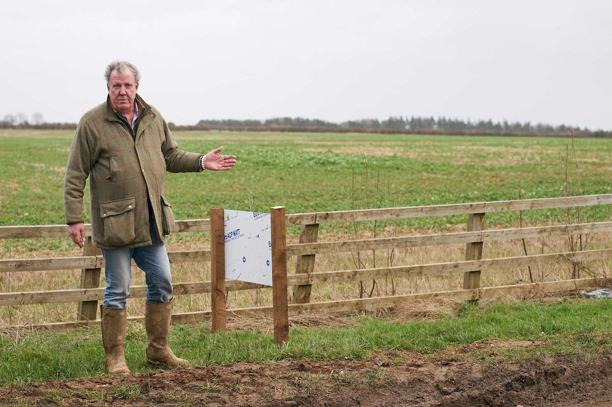 Jeremy Clarkson on his farm in front of a short fence