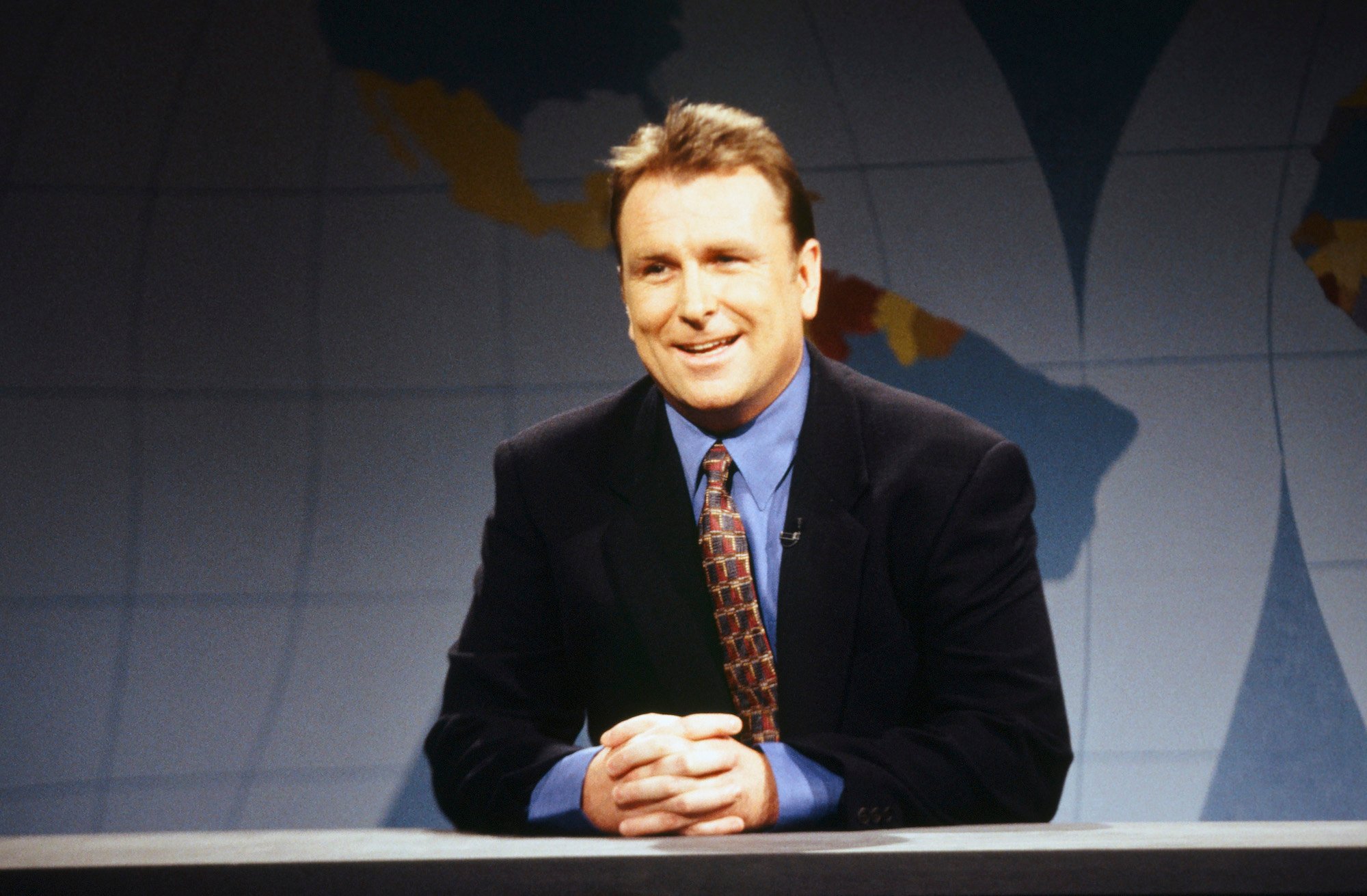 Colin Quinn sits at the SNL Weekend Update desk