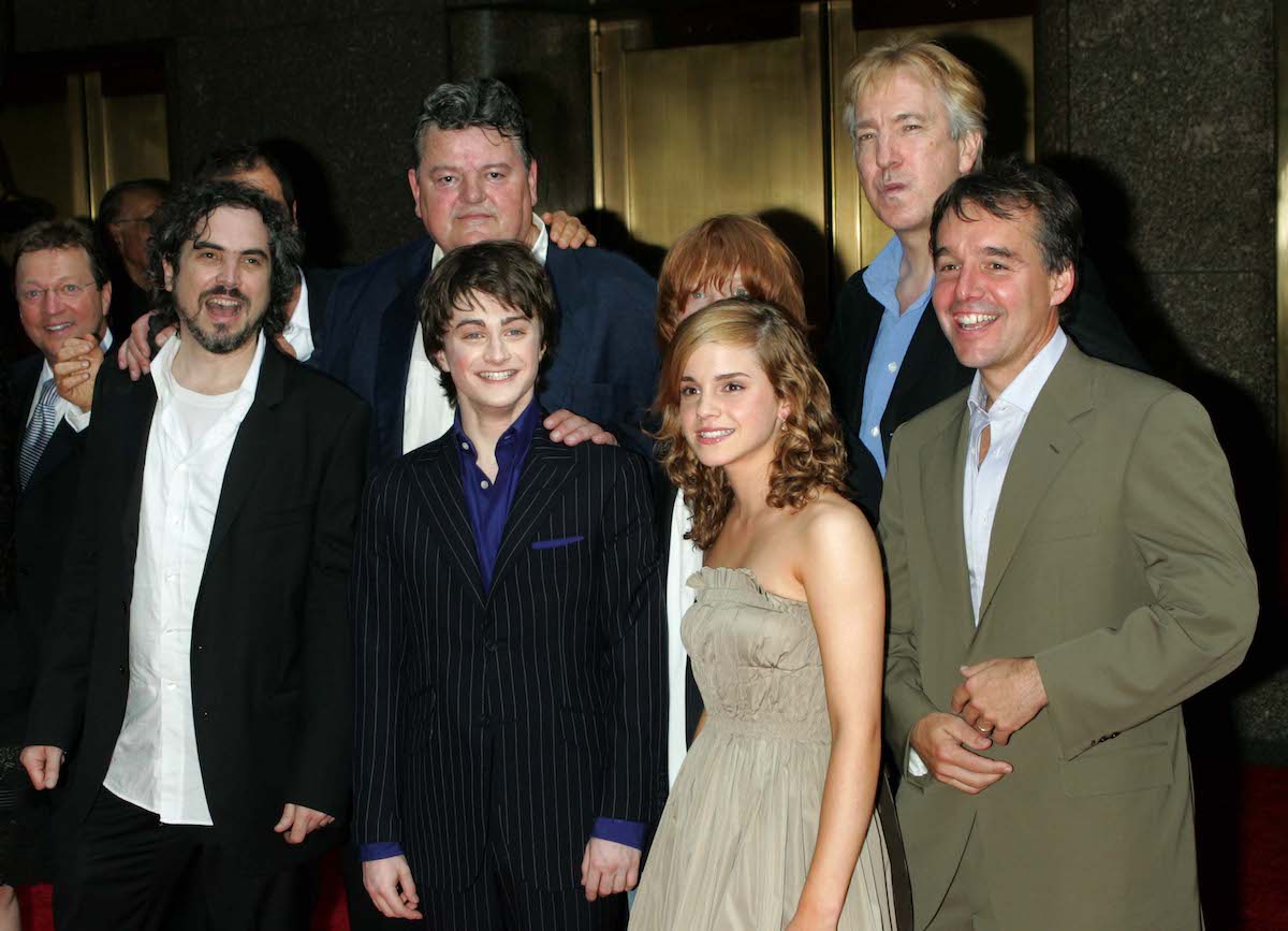 The cast of the 'Harry Potter' film series, including Alan Rickman, Emma Watson, and Daniel Radcliffe, with producer Chris Columbus