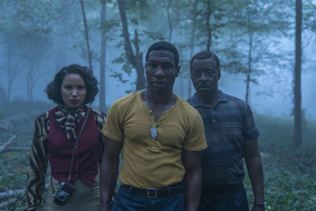 Courtney B. Vance, Jonathan Majors, and Jurnee Smollett standing in the woods in HBO's 'Lovecraft Country.'