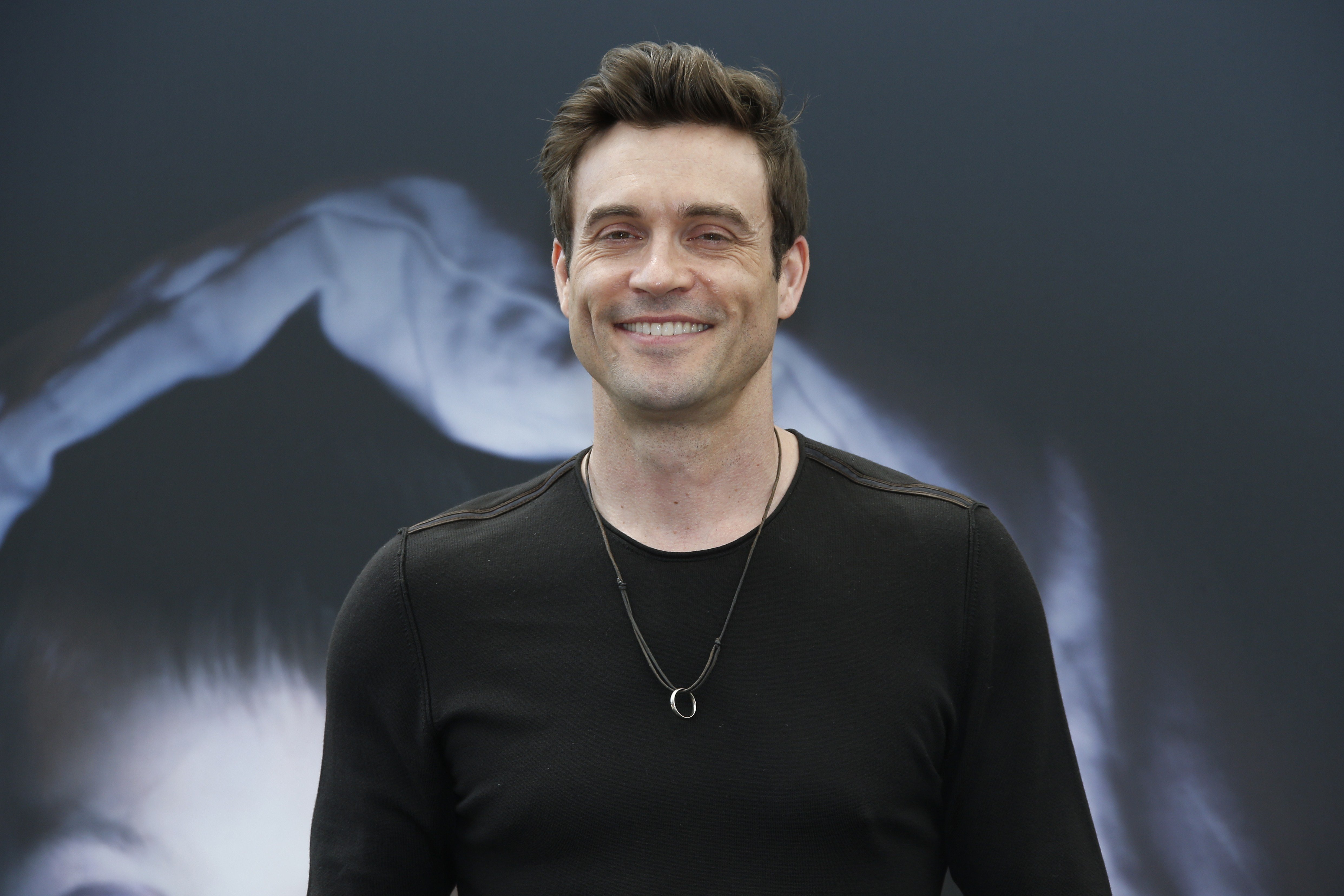 'The Young and the Restless' actor Daniel Goddard wearing a black shirt and smiling for photographers.