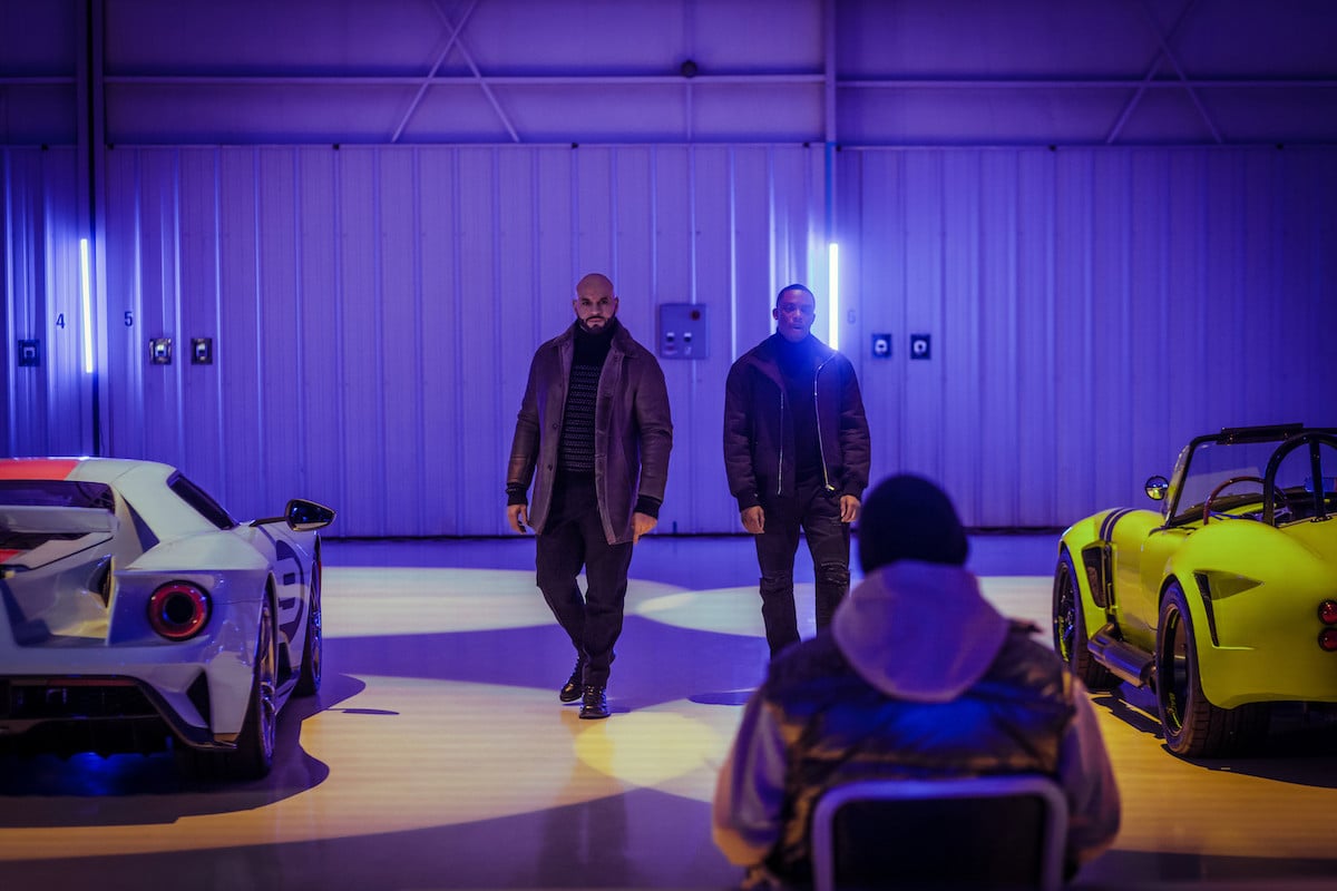 Daniel Sunjata as Mecca and Woody McClain as Cane walking into a purple lit room in 'Power Book II: Ghost'