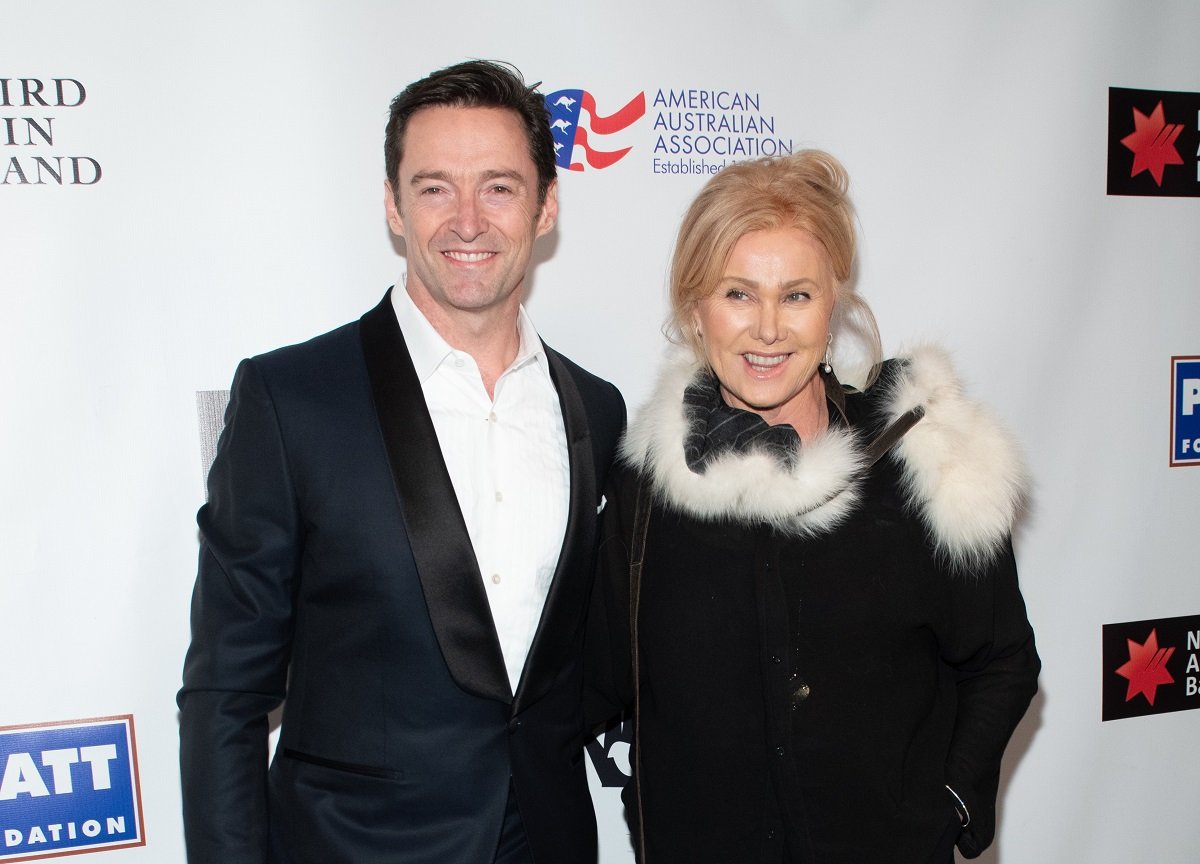 Deborra Lee-Furness and Hugh Jackman smiling while dressed up