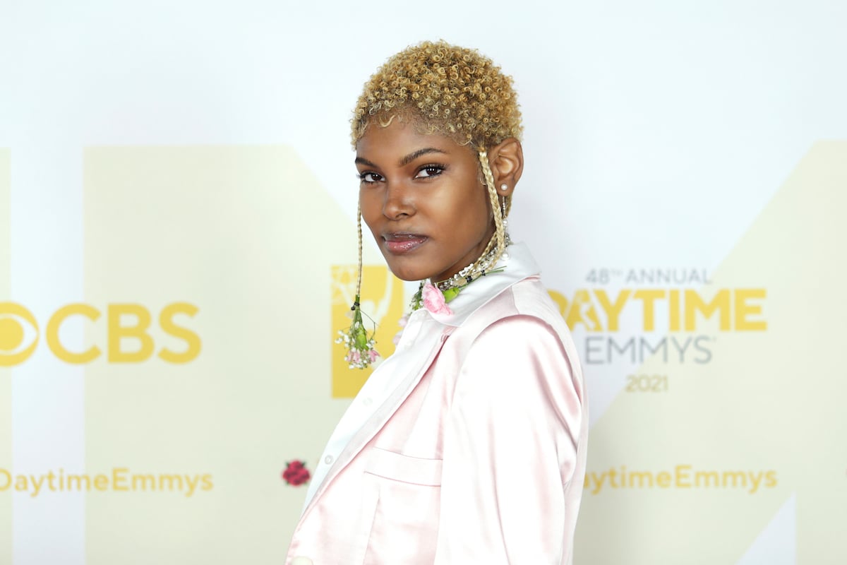 Diamond White smiling in front of a white background