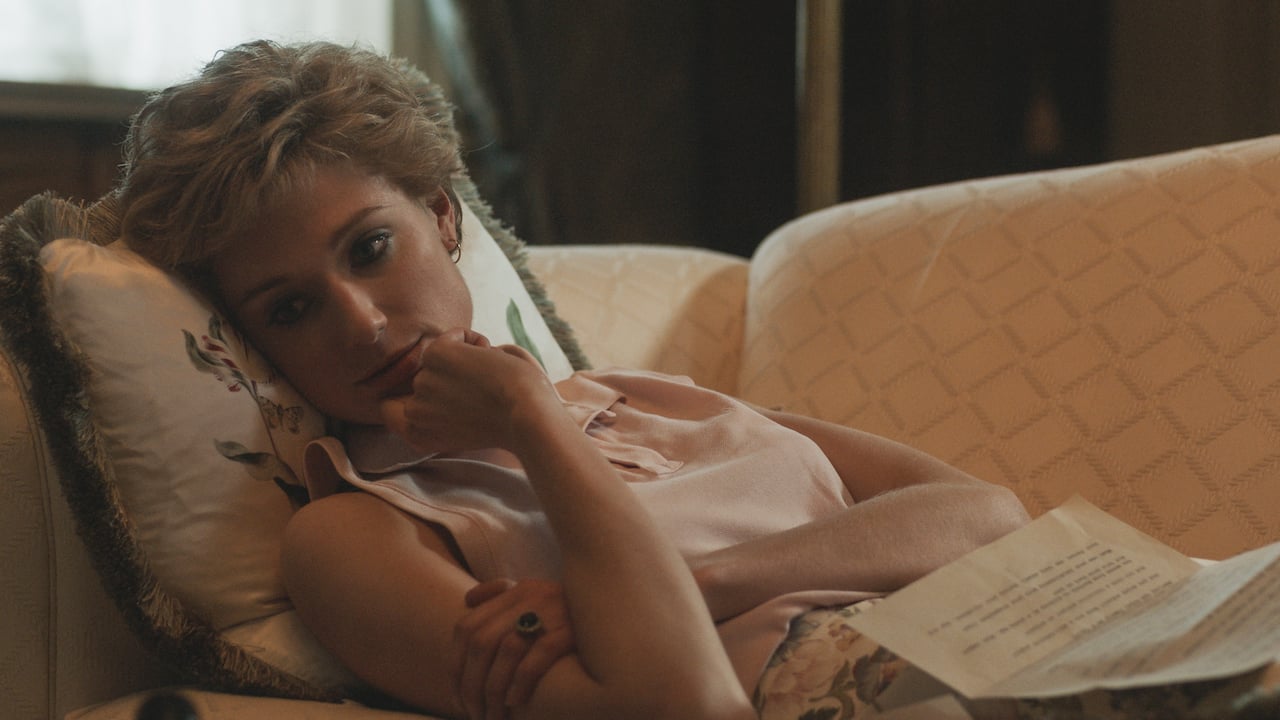 Elizabeth Debicki as Princess Diana in 'The Crown' lies down on a couch looking sad.