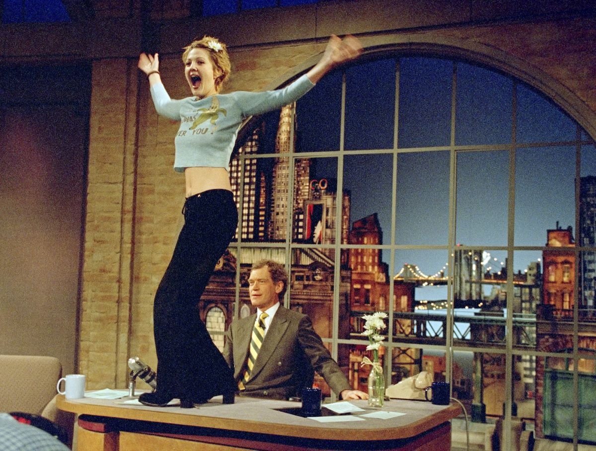 Drew Barrymore turns to the audience after flashing host David Letterman