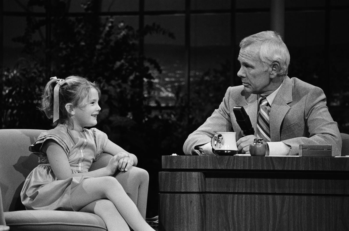Drew Barrymore, 7, sits beside host Johnny Carson for an interview on 'The Tonight Show'