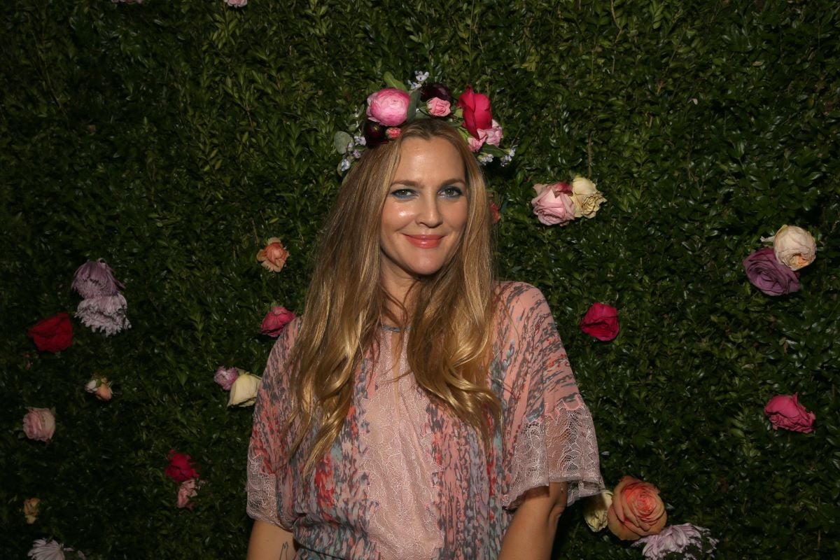 Drew Barrymore in a floral crown, hair down, and wearing pink