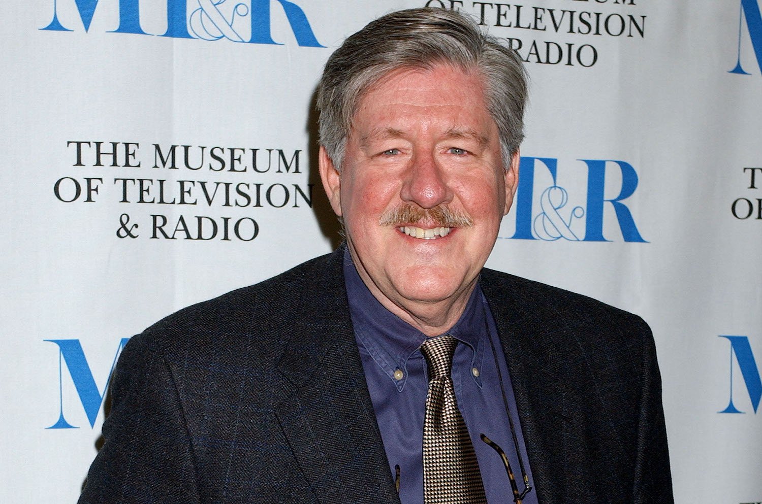Edward Herrmann smiles as he poses for photos at an event to mark 100 episodes of 'Gilmore Girls'