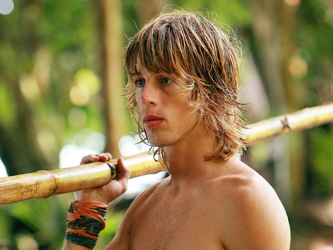 'Survivor: Micronesia' star Erik Reichenbach wears his tribe buff around his wrist and carries a stick of bamboo.