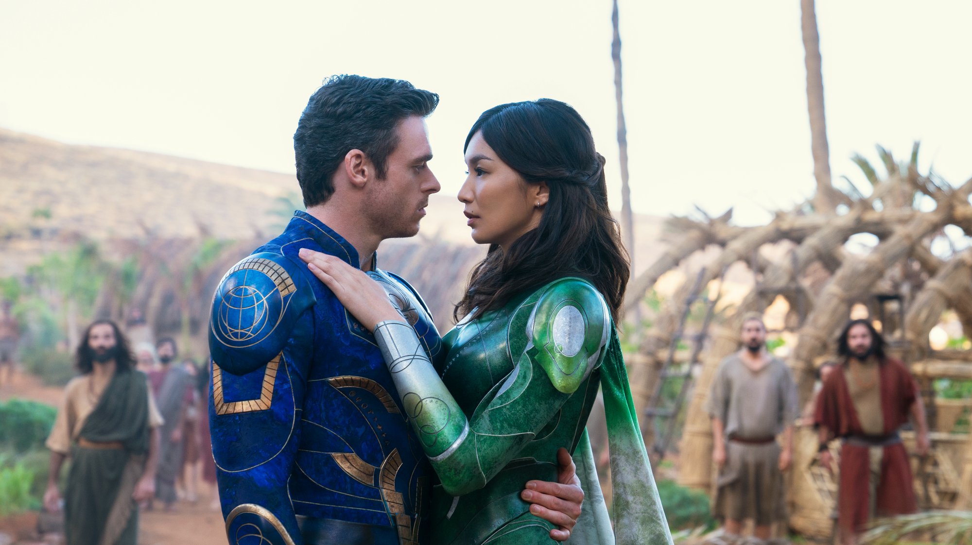 'Eternals' Ikaris (Richard Madden) and Sersi (Gemma Chan) embracing each other in superhero costumes