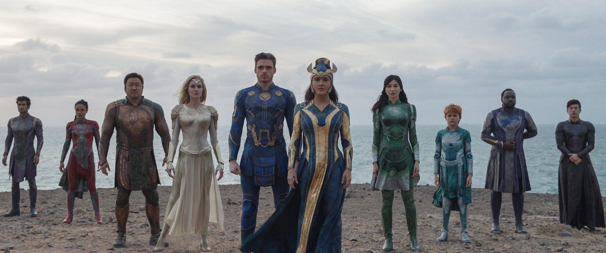 'Eternals' Kingo (Kumail Nanjiani), Makkari (Lauren Ridloff), Gilgamesh (Don Lee), Thena (Angelina Jolie), Ikaris (Richard Madden), Ajak (Salma Hayek), Sersi (Gemma Chan), Sprite (Lia McHugh), Phastos (Brian Tyree Henry), and Druig (Barry Keoghan) standing in superhero poses