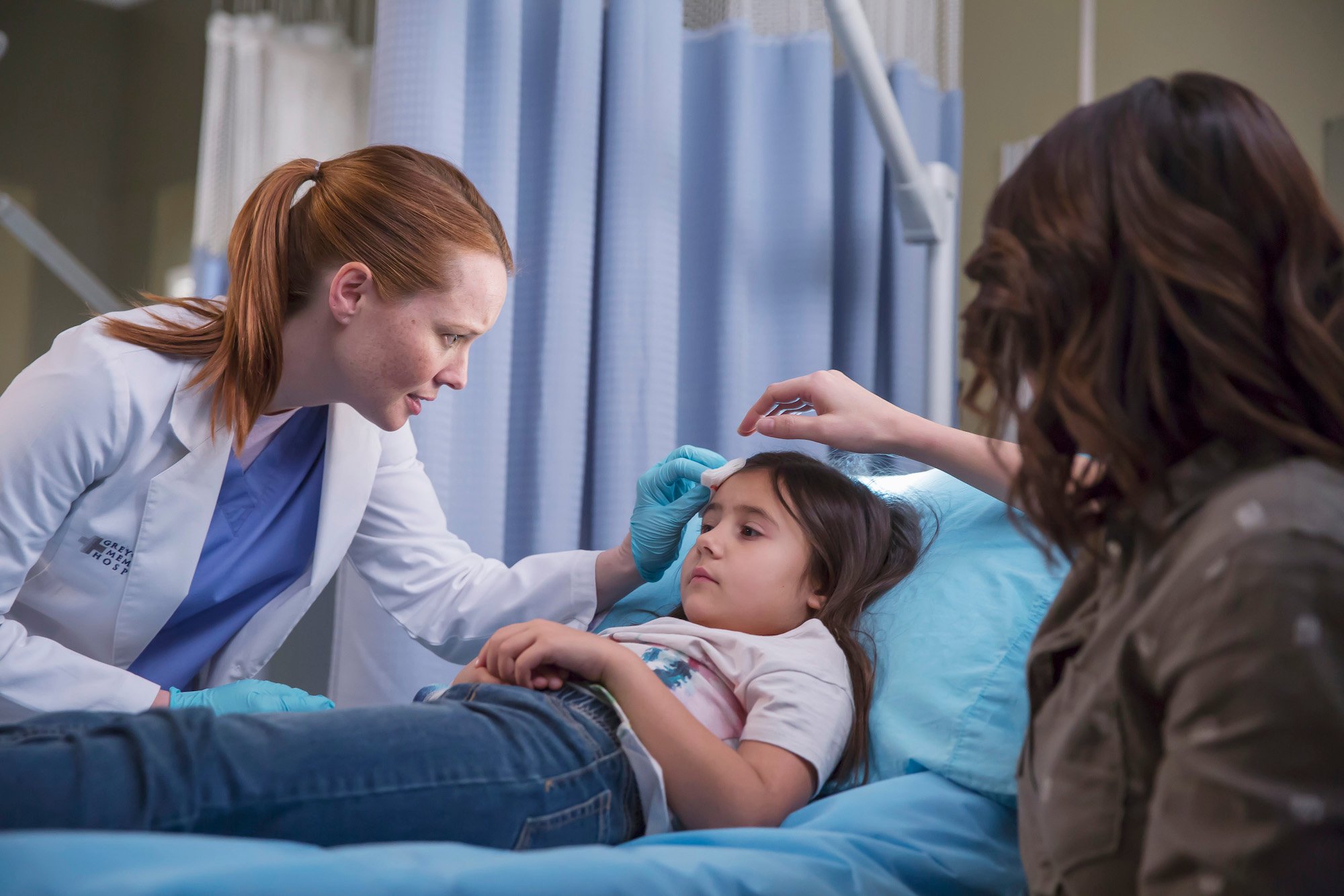 Eva Arial Binder laying in a hospital bed in 'Grey's Anatomy.'