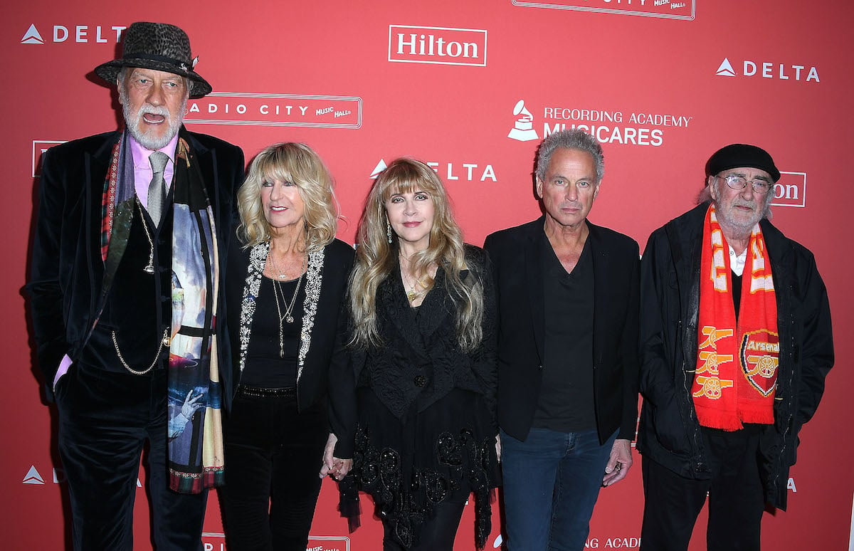 Mick Fleetwood, Christine McVie, Stevie Nicks, Lindsey Buckingham, and John McVie of Fleetwood Mac pose together at an event.