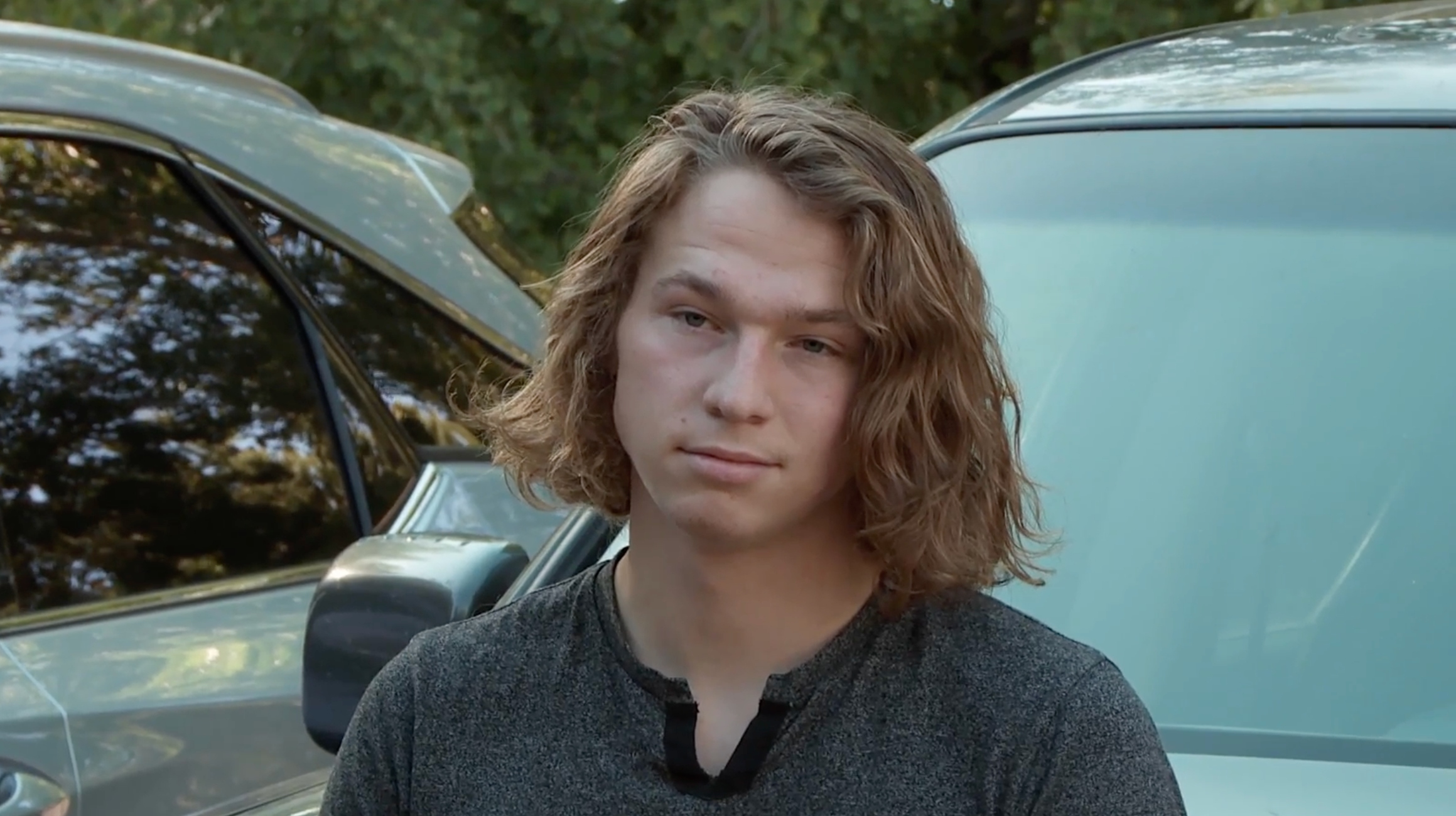 Gabriel 'Gabe' Brown standing in front of a car on 'Sister Wives' Season 16 on TLC