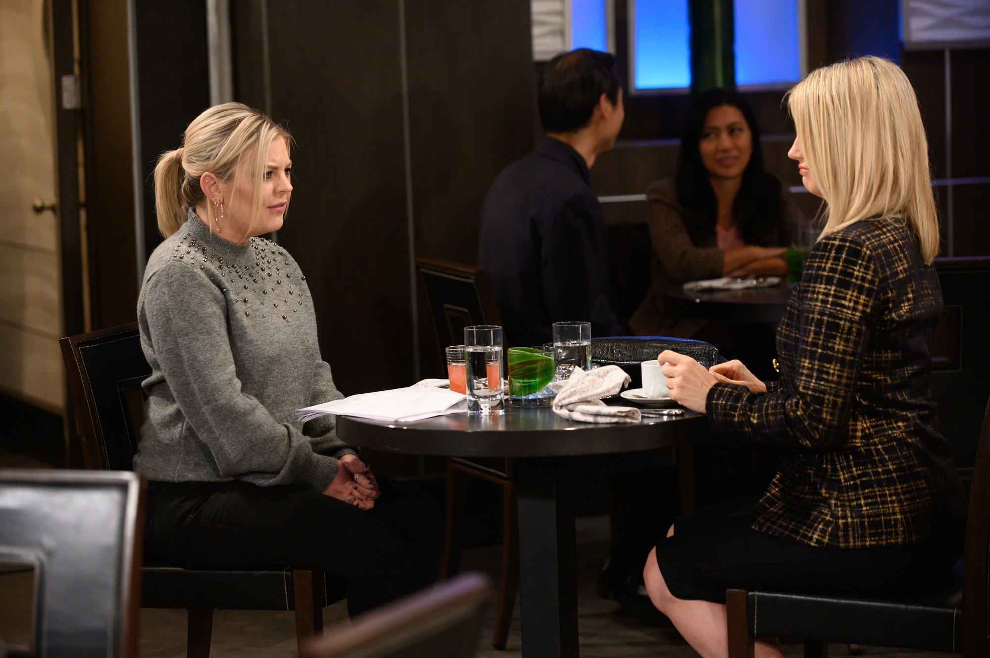 General Hospital spoilers focus on Maxie, L, in a pale dress, and Nina, R, in a tweed suit