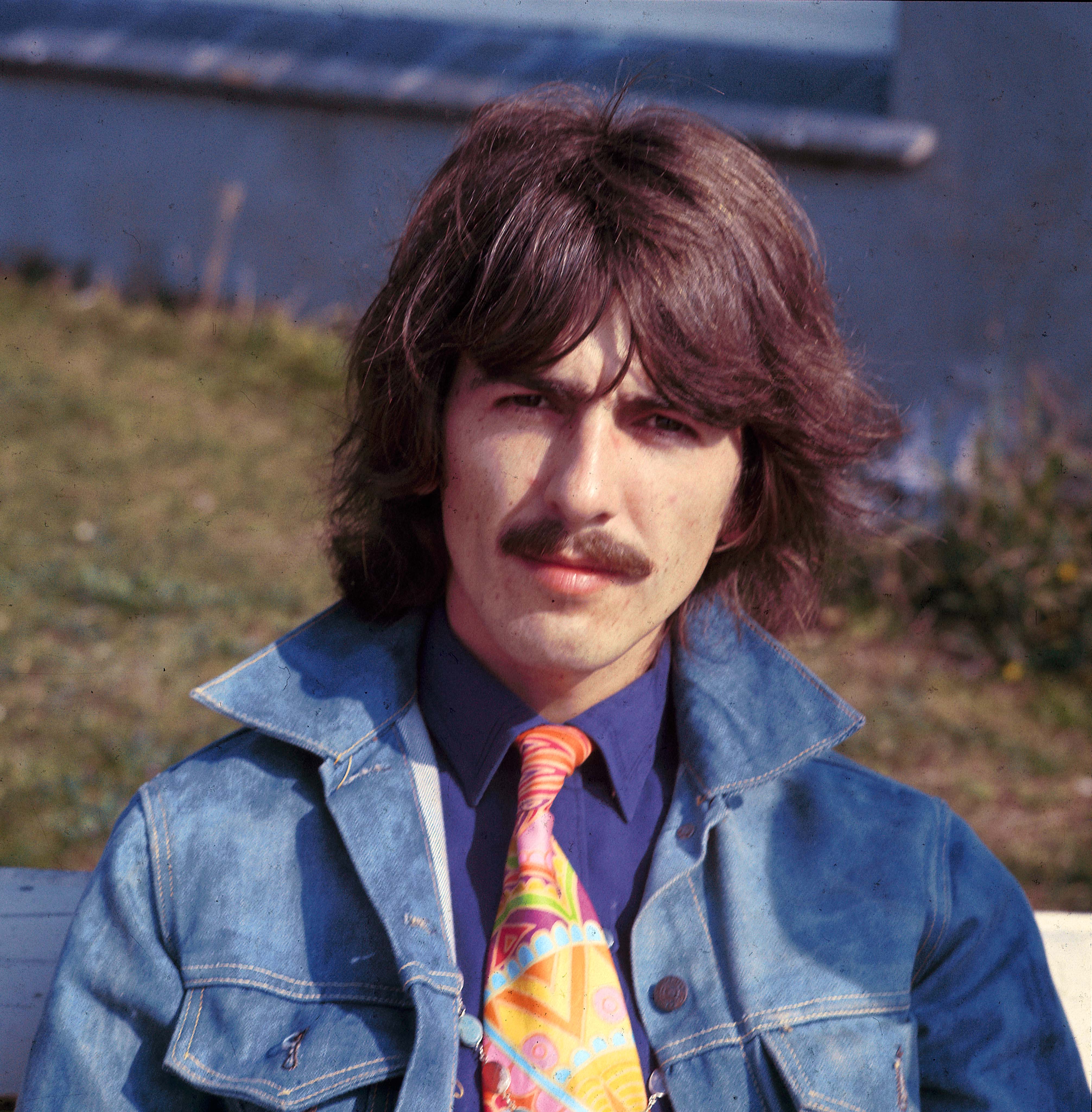 George Harrison of The Beatles, wearing a denim jacket, takes part in filming of the television musical film 'Magical Mystery Tour' in Plymouth, Devon on September 12, 1967.