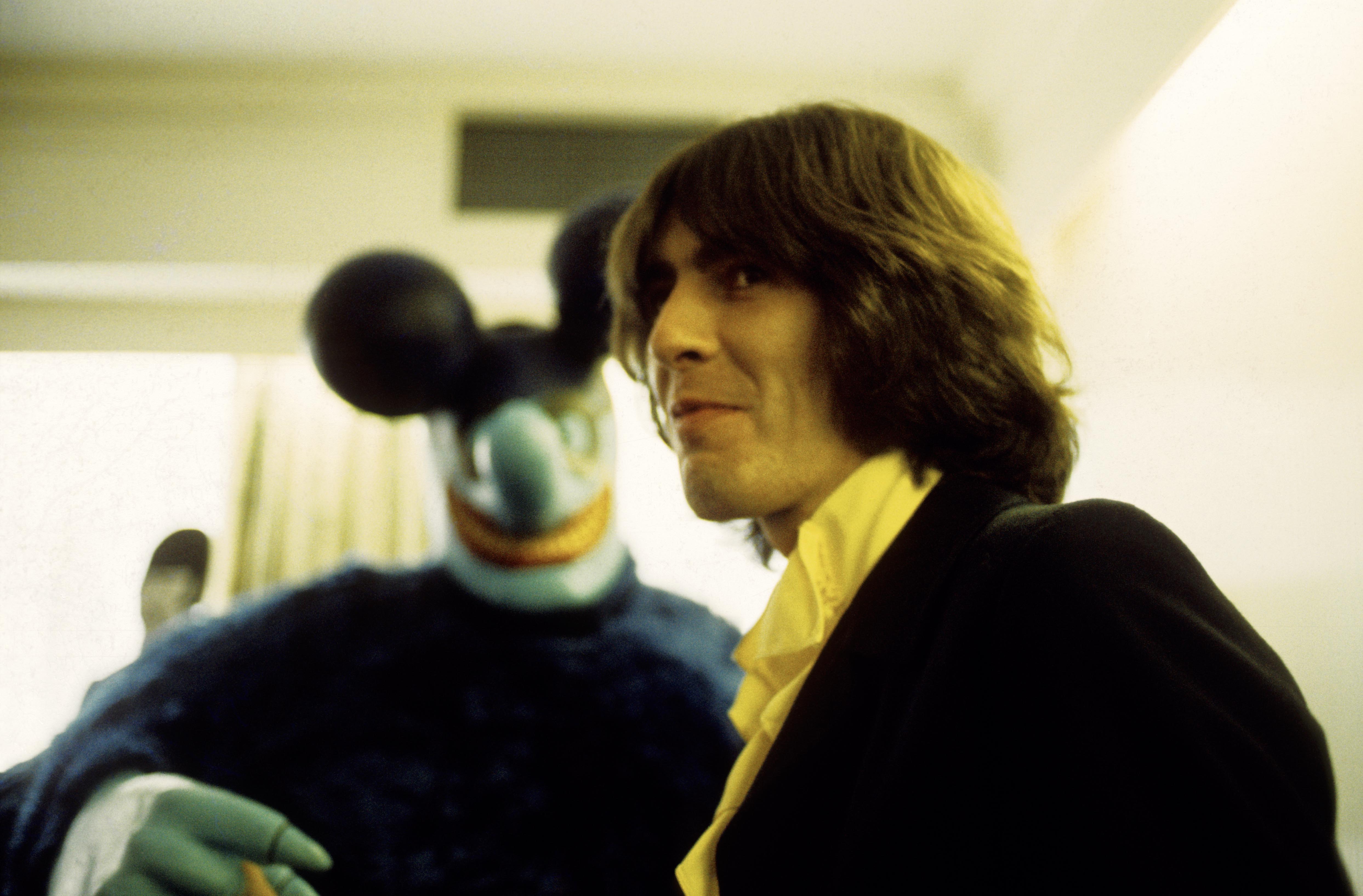 George Harrison with a Blue Meanie at the press screening of the film 'Yellow Submarine'