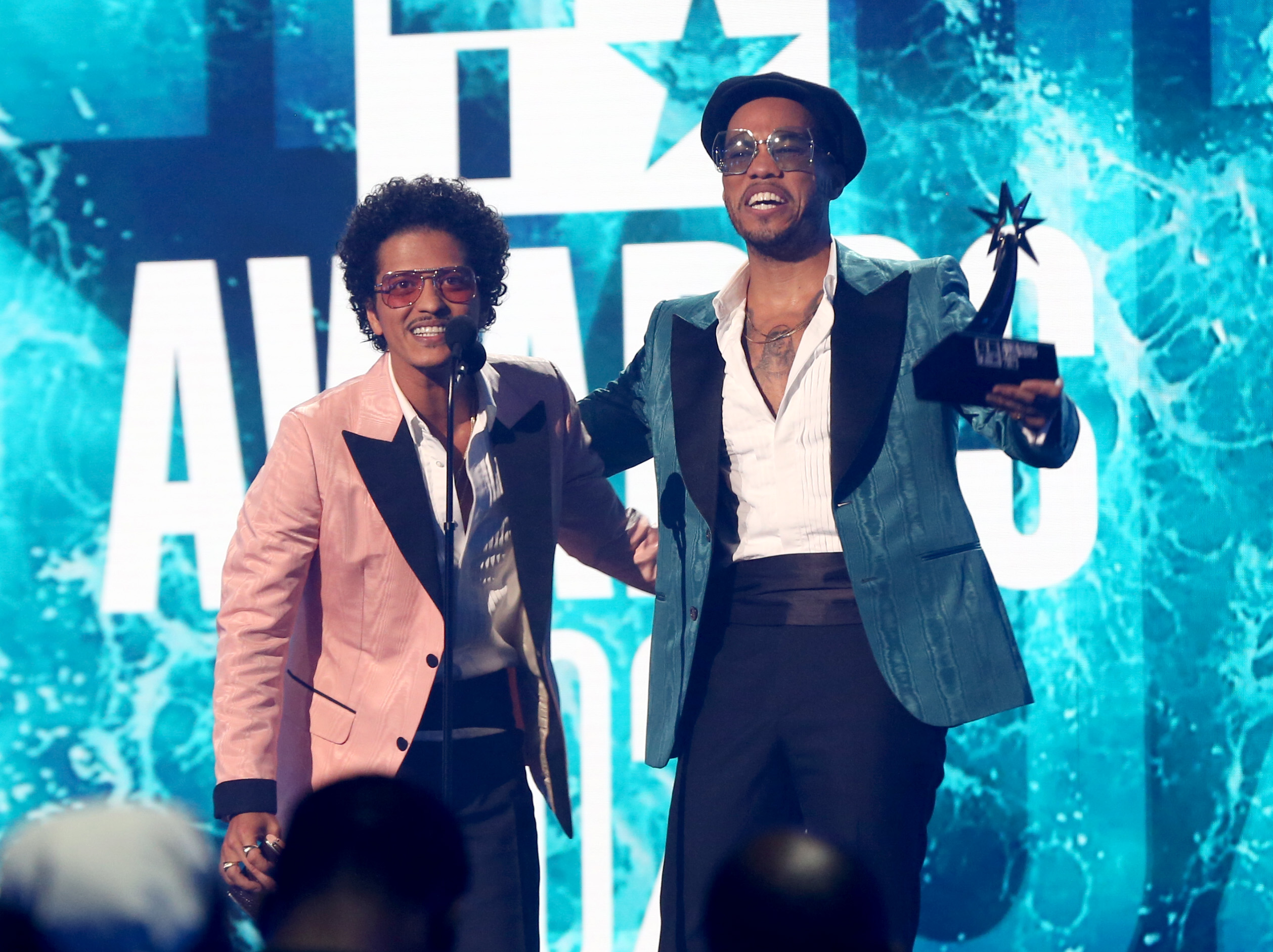 Bruno Mars and Anderson .Paak of Silk Sonic smiling accepting an award