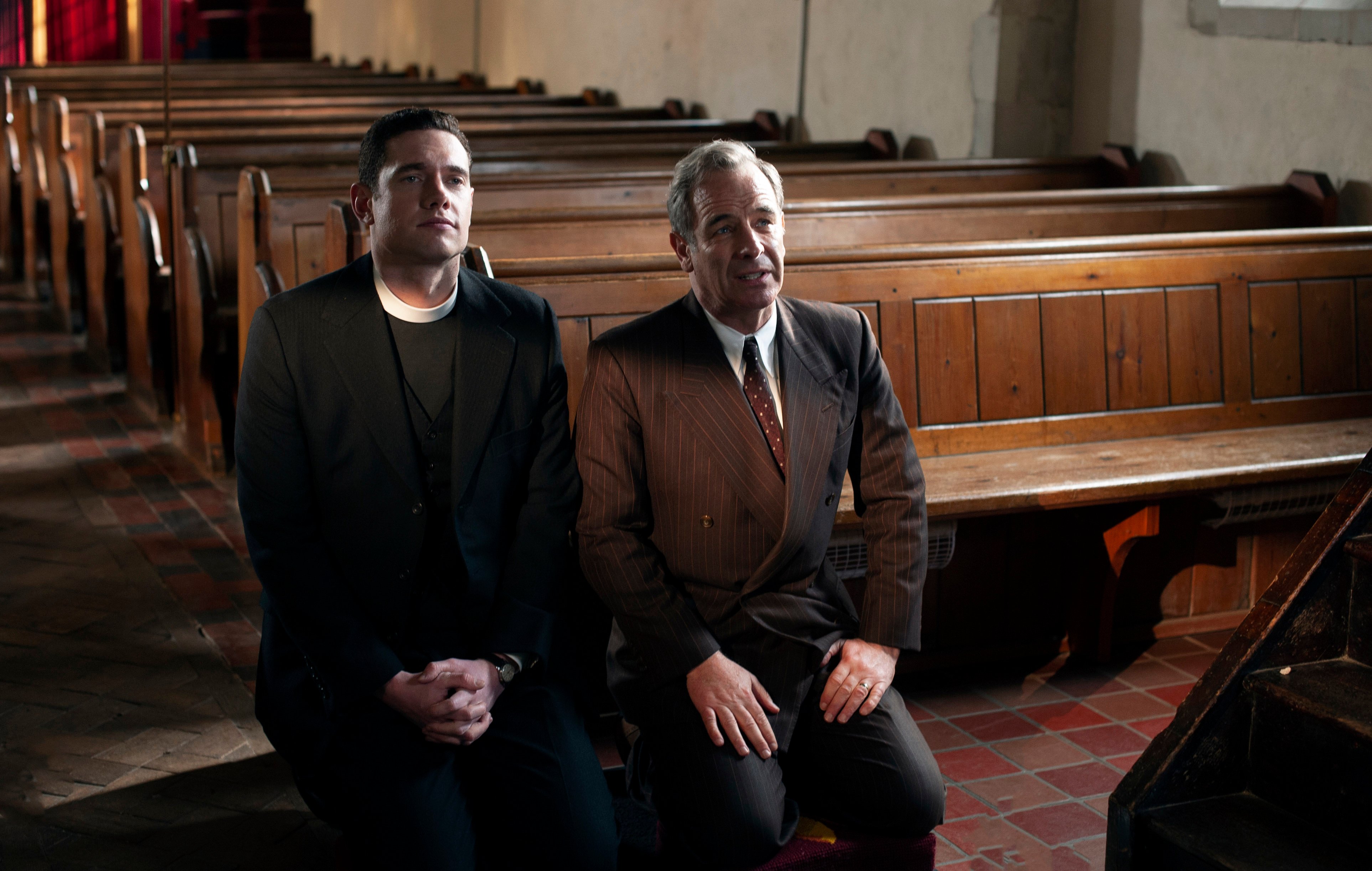 Will and Geordie sitting on a church pew in the 'Grantchester' Season 6 finale