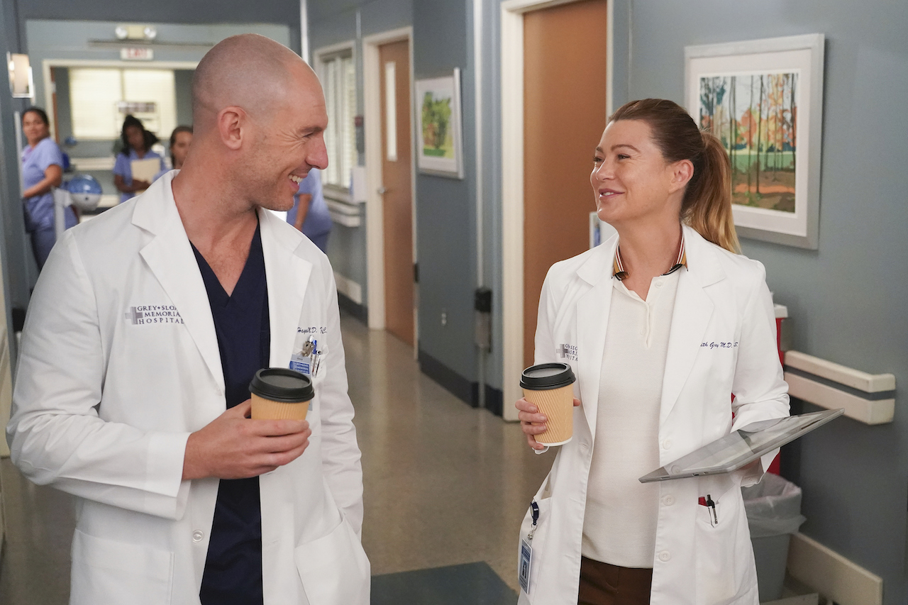 Richard Flood as Cormac Hayes and Ellen Pompeo as Meredith Grey walk in a hallway on 'Grey's Anatomy'