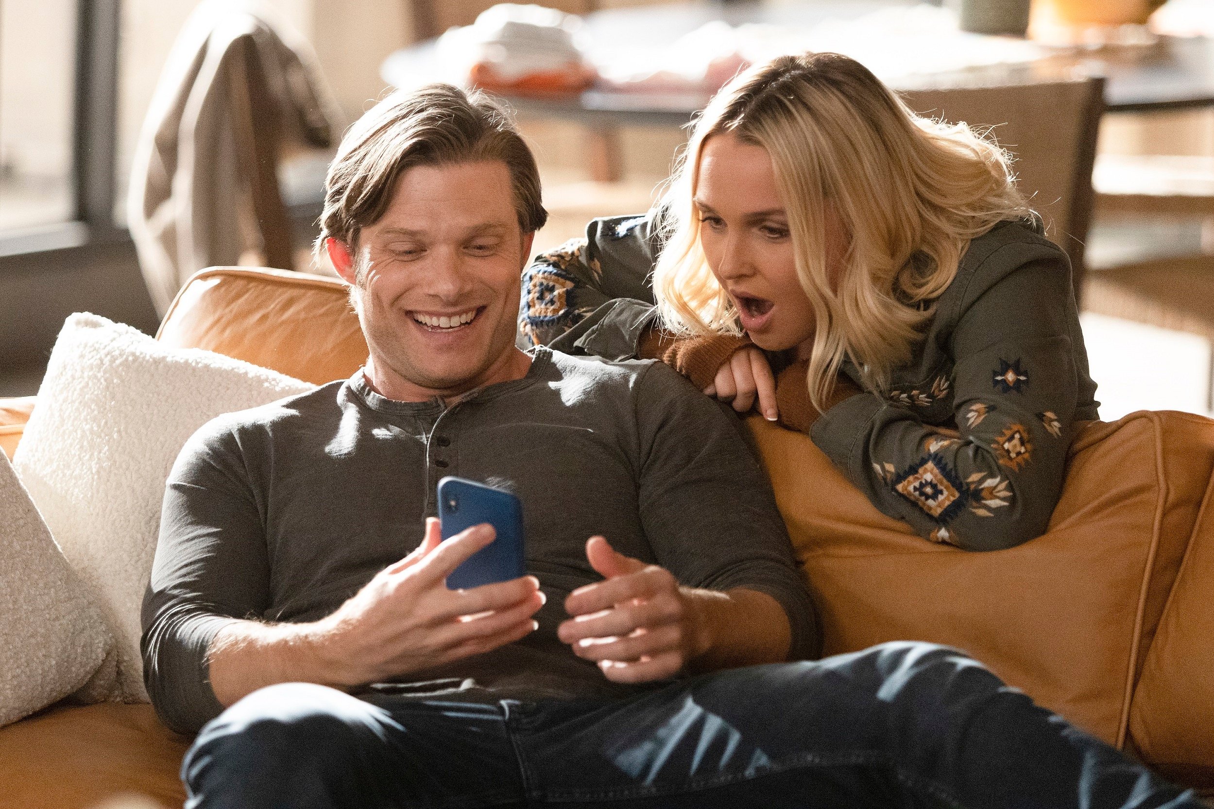 'Grey's Anatomy' cast members Chris Carmack and Camilla Luddington looking at a phone together as Link and Jo