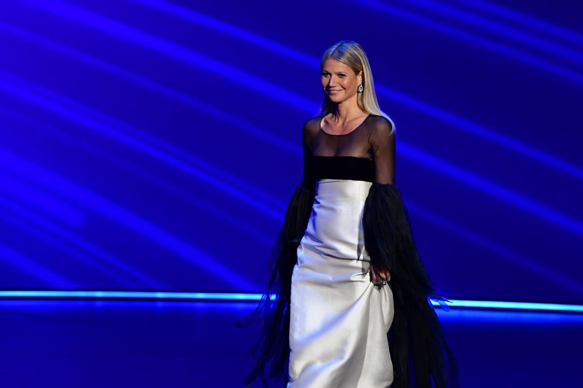 Gwyneth Paltrow smiling on stage in a dress.